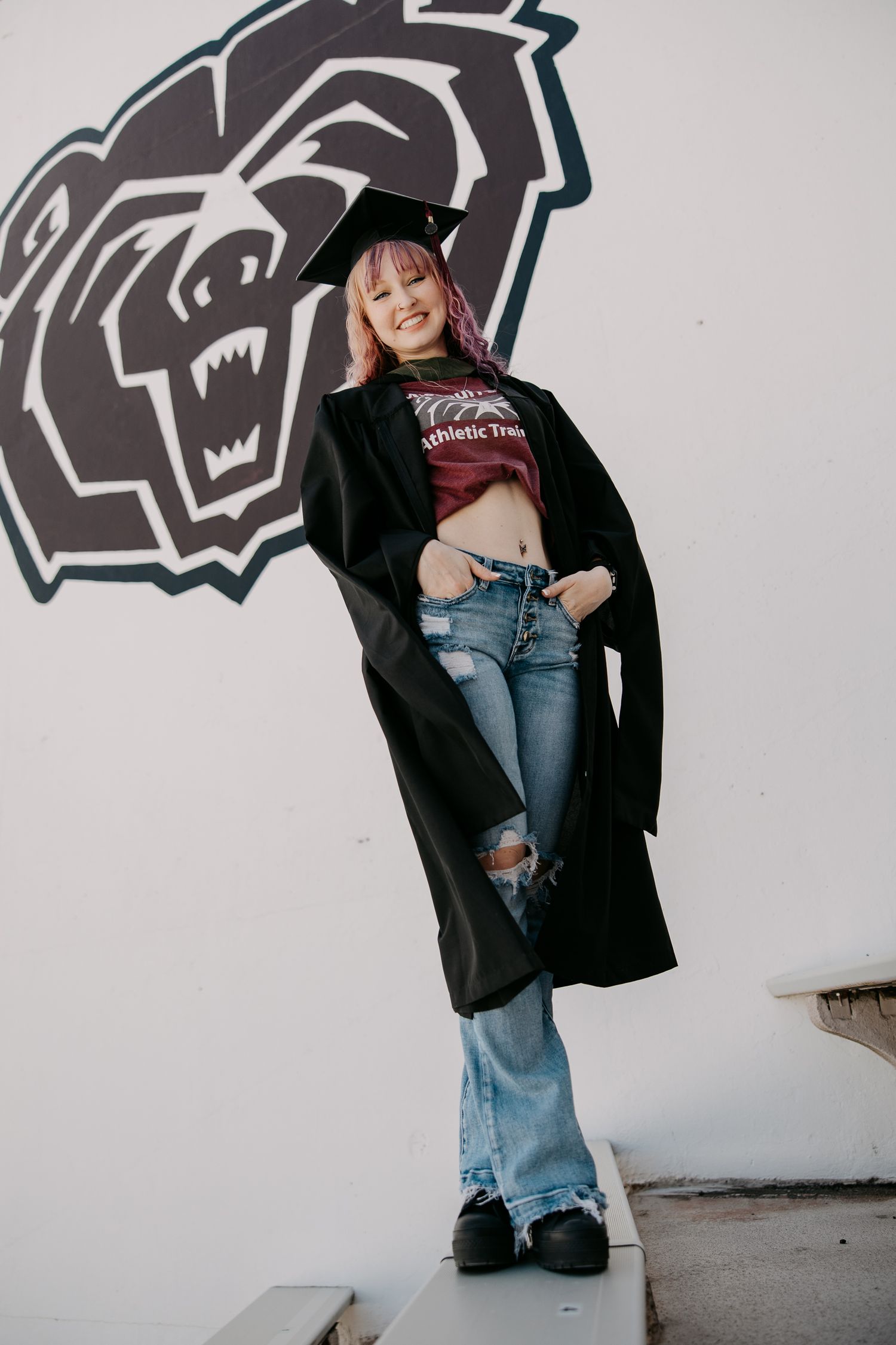 People pose playfully against white wall with black panther logo design.