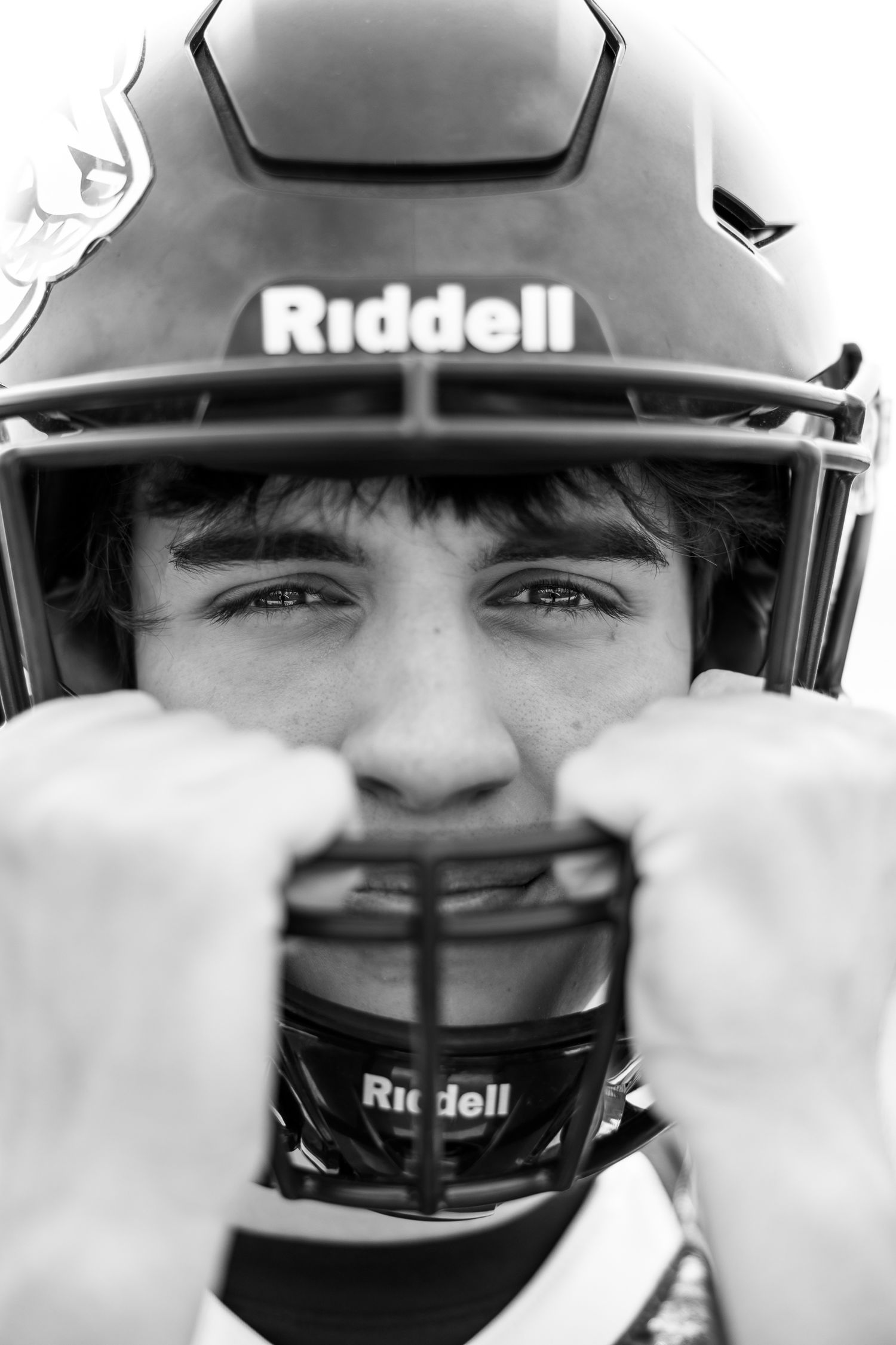 Close-up view of Riddell football helmets showing protective face masks.