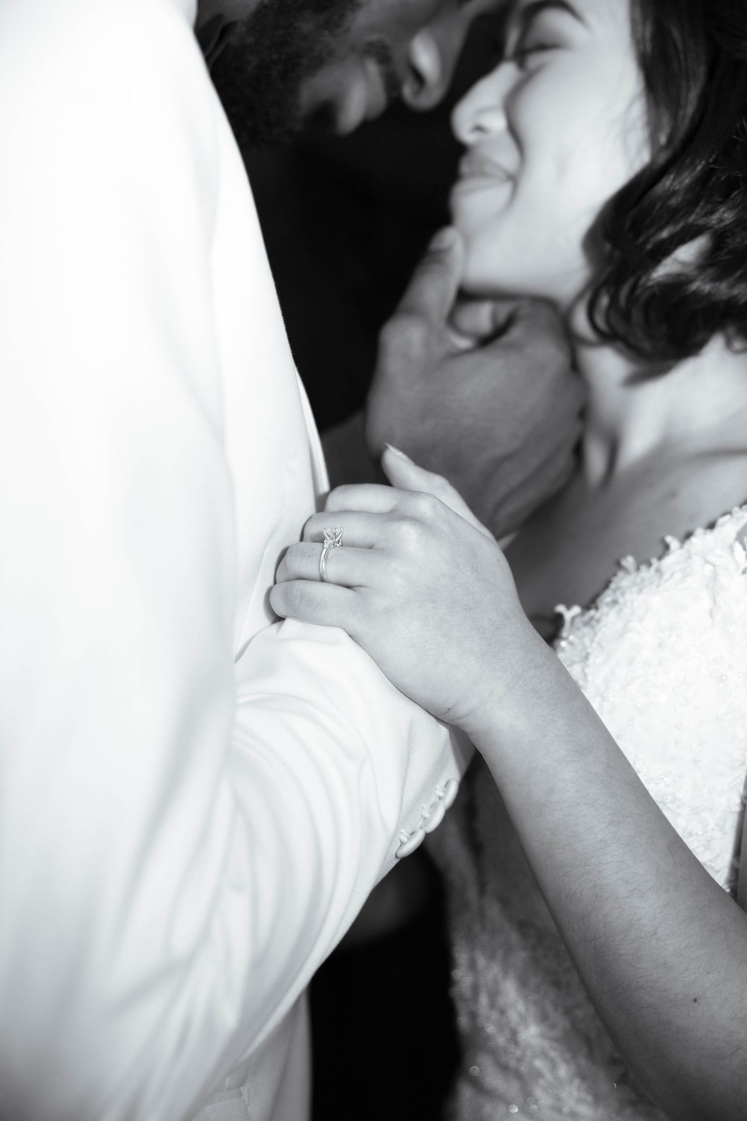 Black and white wedding photography series capturing intimate moments between bride and groom.