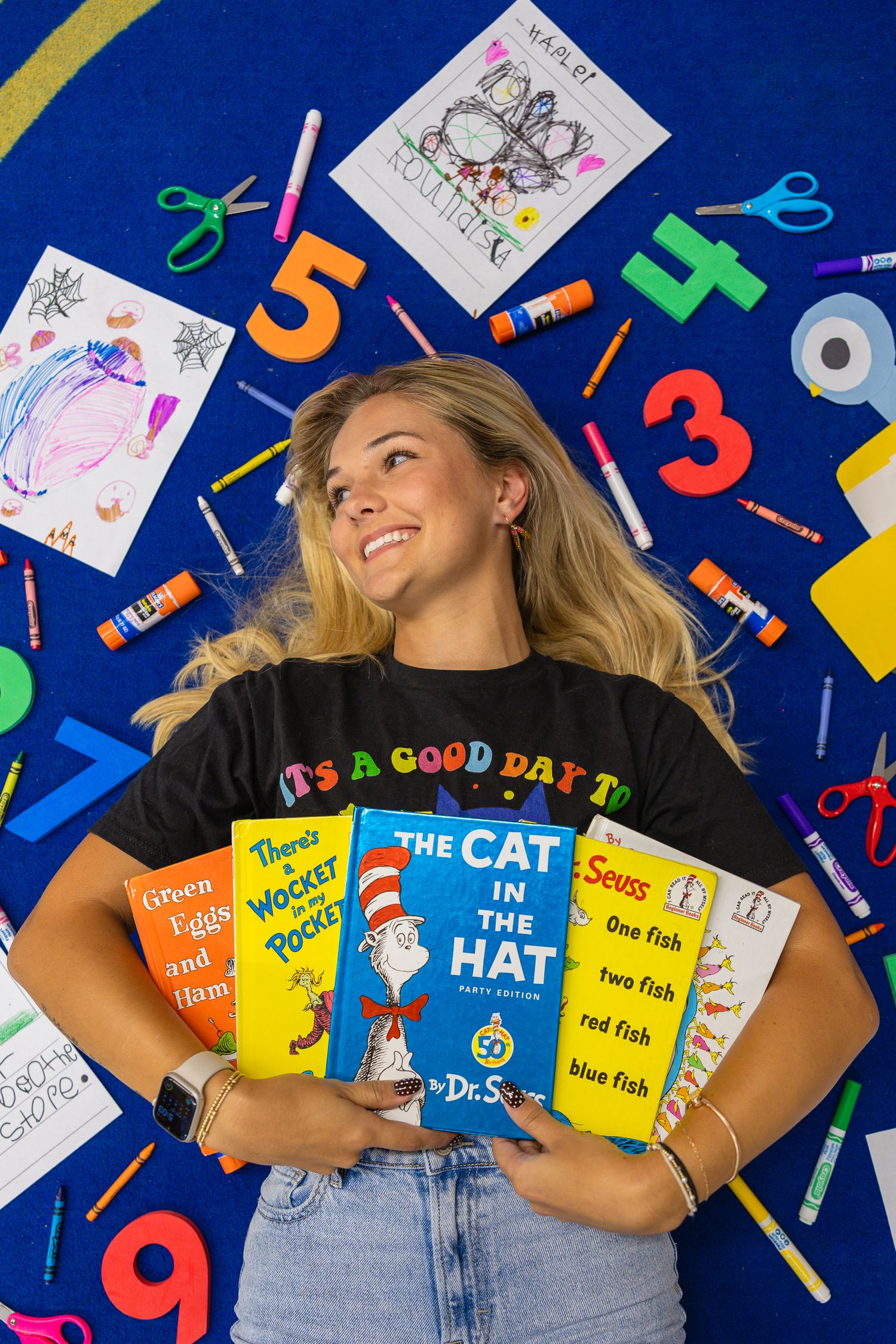 Colorful classroom setup with Dr. Seuss books and educational materials on blue background.