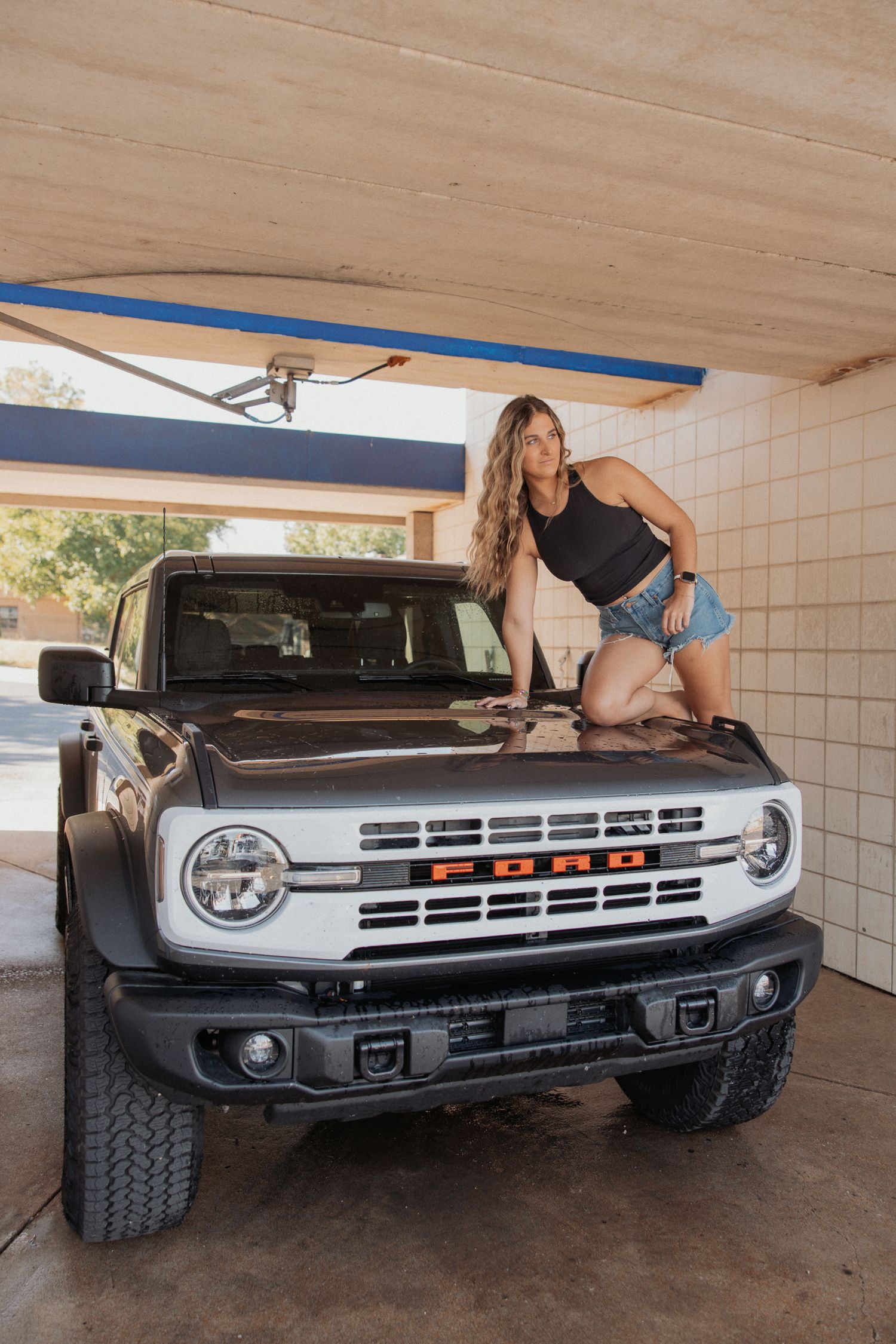 Modern Ford Bronco showcased in covered parking area with distinctive front end styling.