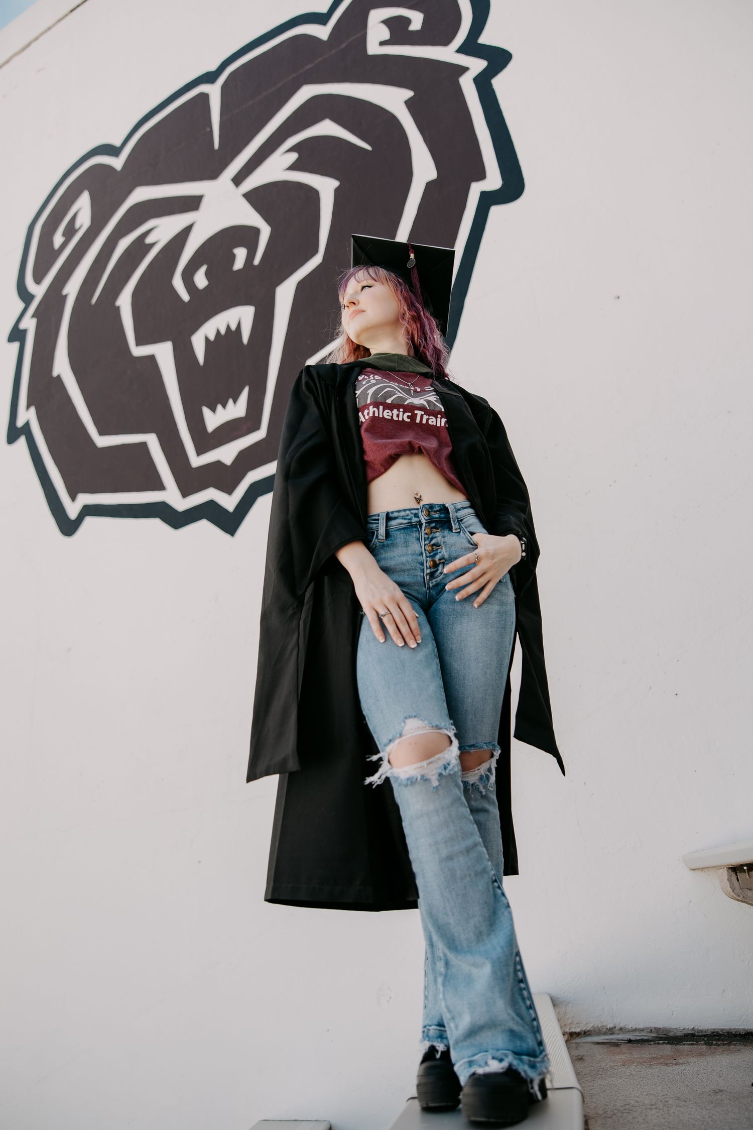 People in casual wear pose against white wall with black graphic design.