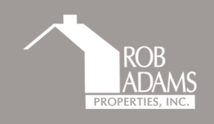A row of real estate company logos displayed in grayscale on a light gray background.
