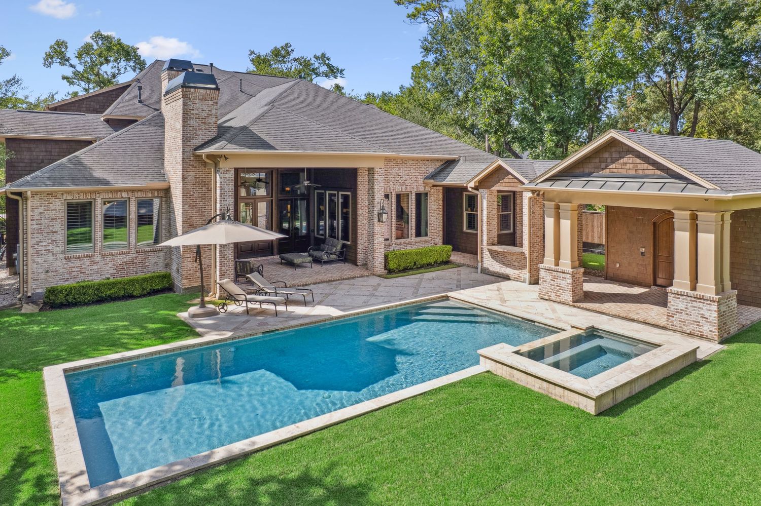Aerial view of multiple luxury homes with swimming pools and manicured lawns.
