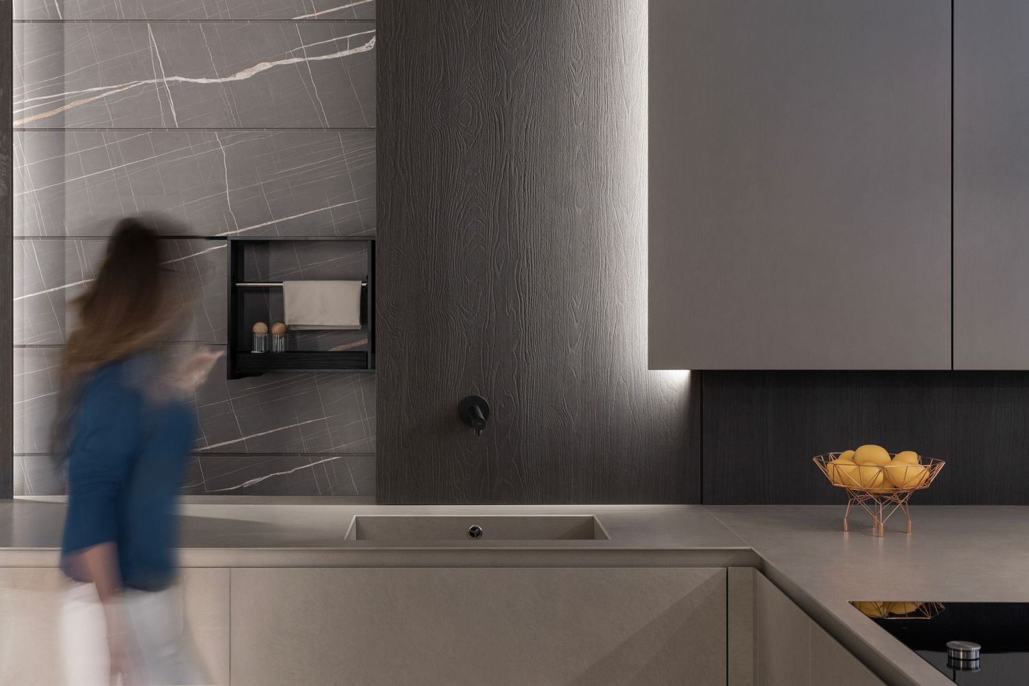 Bright modern kitchen with white countertops and stainless steel appliances in an urban setting.