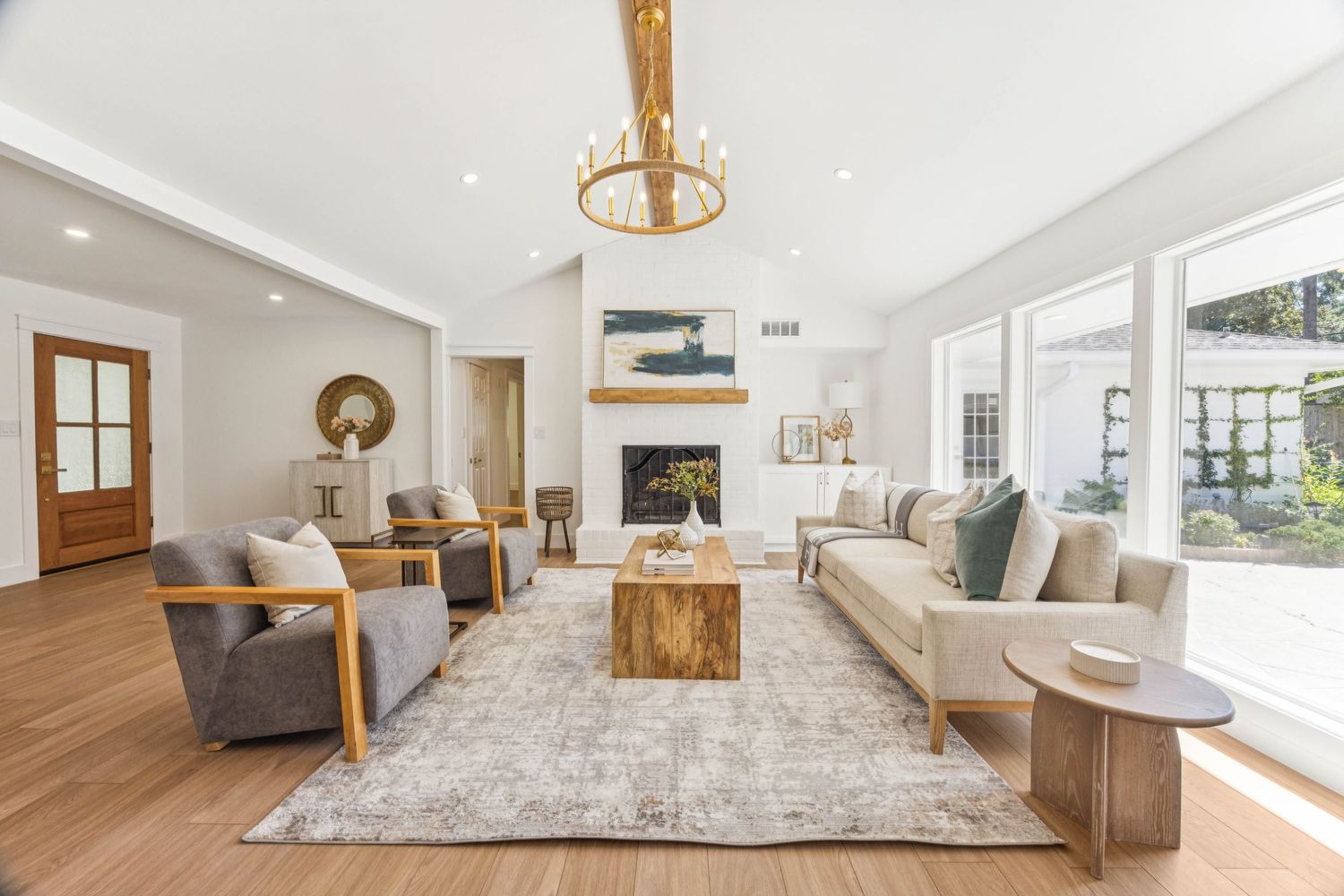 Contemporary open floor plan living space with natural light and modern furnishings in neutral tones.
