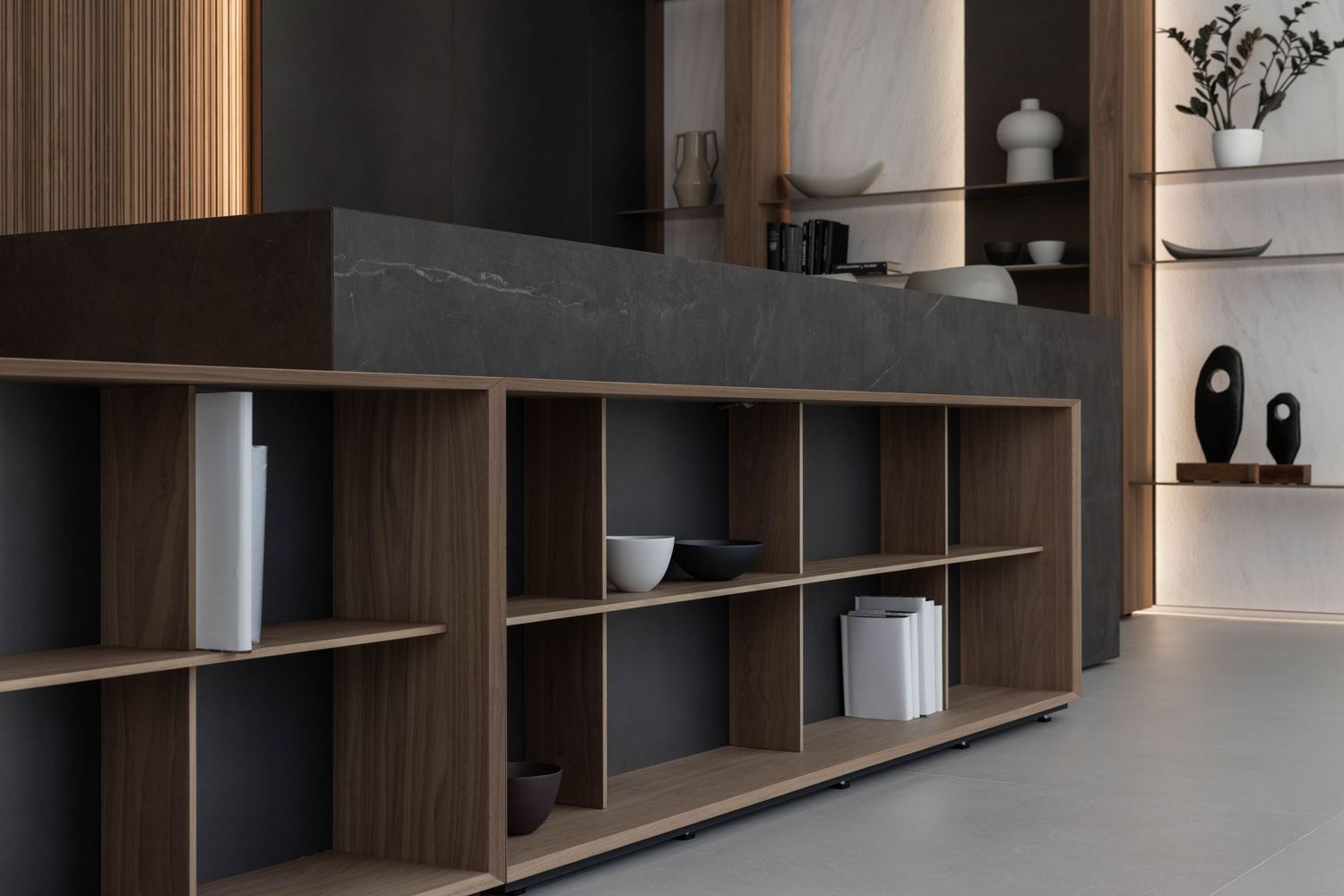 Custom built-in shelving with integrated lighting and decorative display spaces.