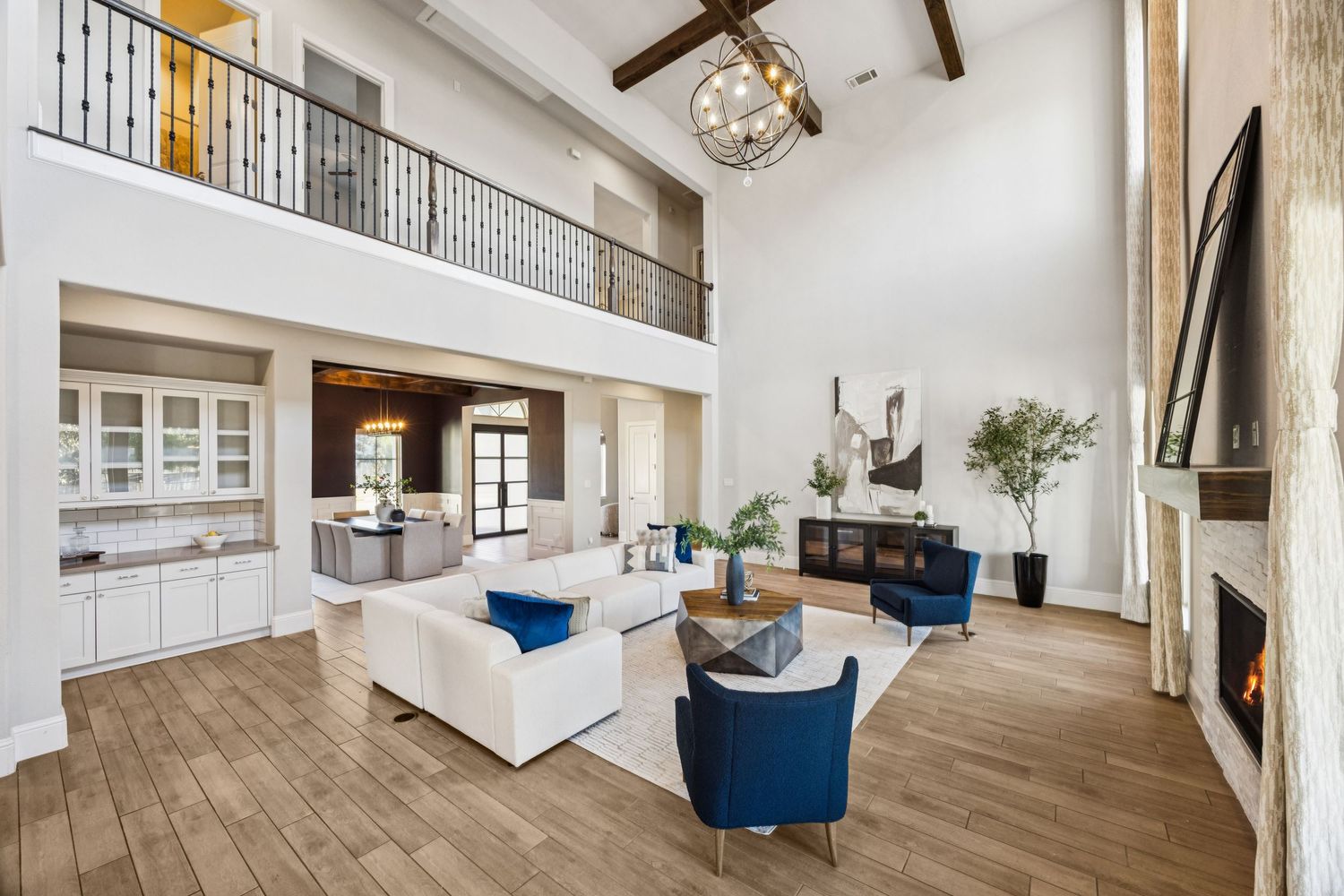 Large open-plan living space with vaulted ceilings, wooden beams, and comfortable seating areas.