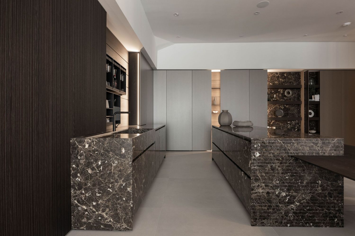 Modern living room with stone accent wall, white upholstered chairs, and minimalist decor.