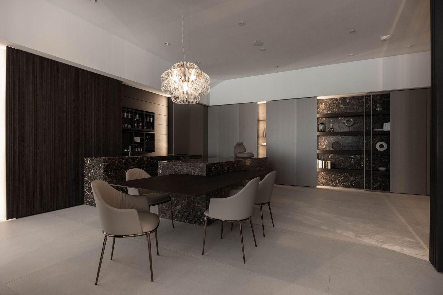 Sleek open concept living area with crystal chandelier and modern furnishings.