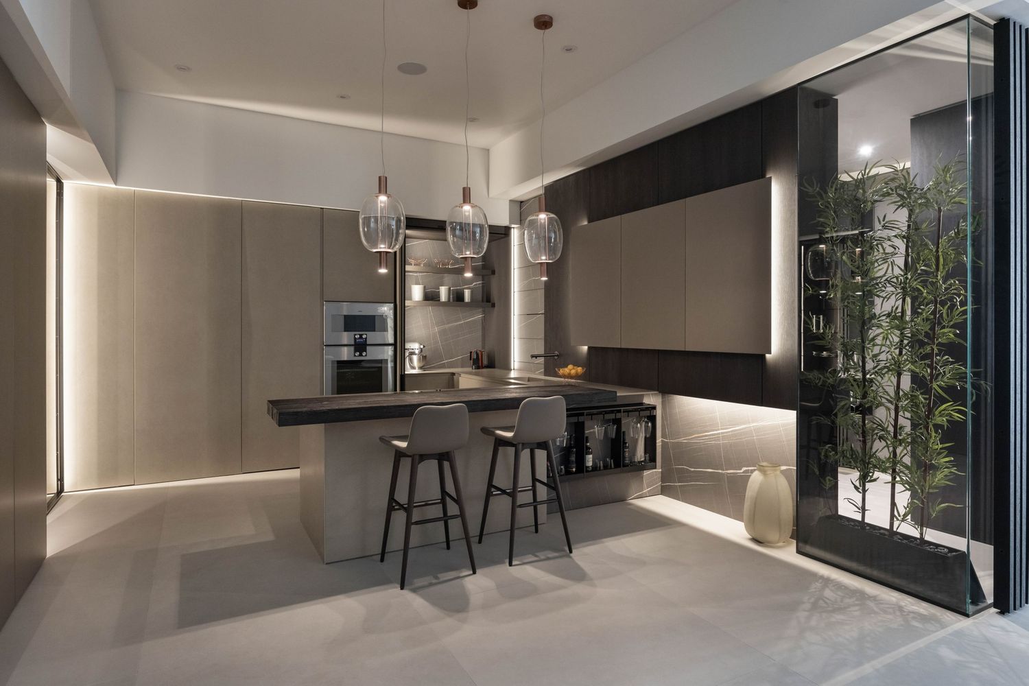 Contemporary open concept kitchen featuring clean lines, pendant lighting, and bar seating.