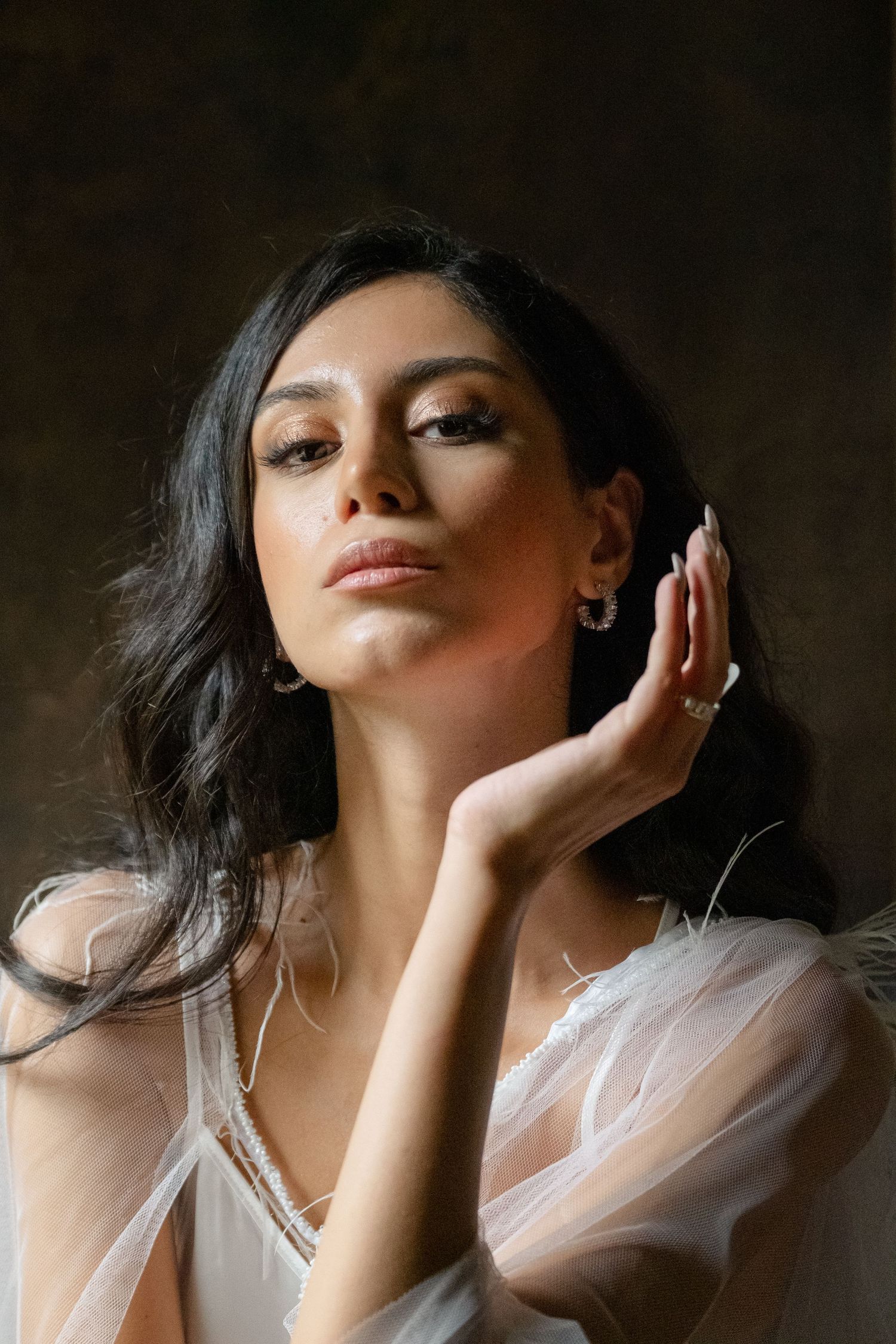 Soft, dreamy portrait series with delicate white fabric and dramatic lighting.