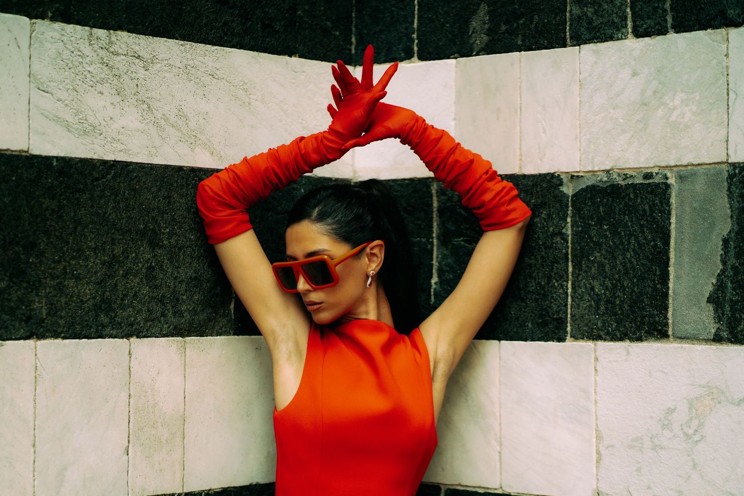 Model poses for editorial shoot in the streets of Tuscany region in Italy