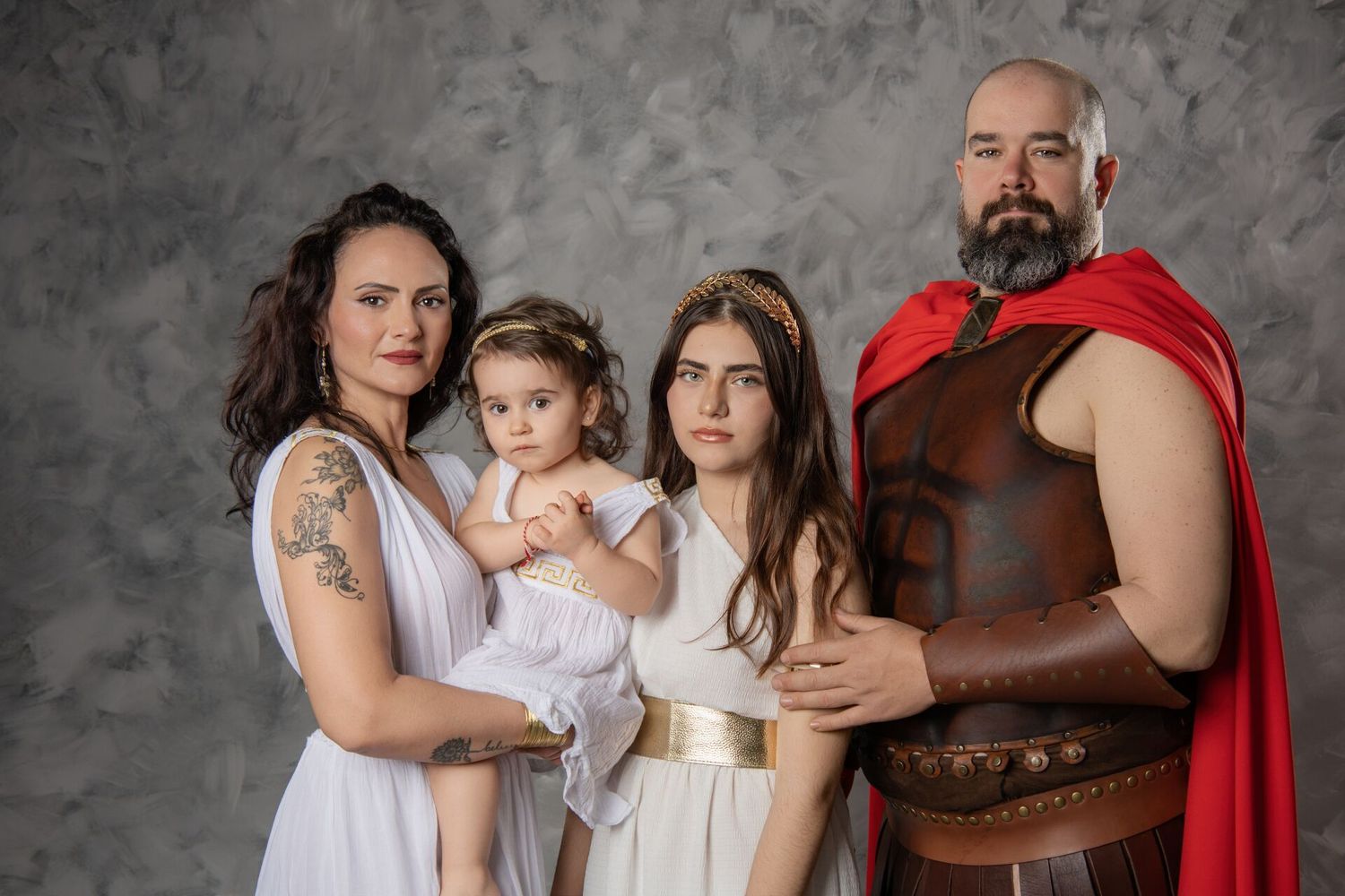 A series of family portraits against a textured gray backdrop showing tender moments between loved ones.