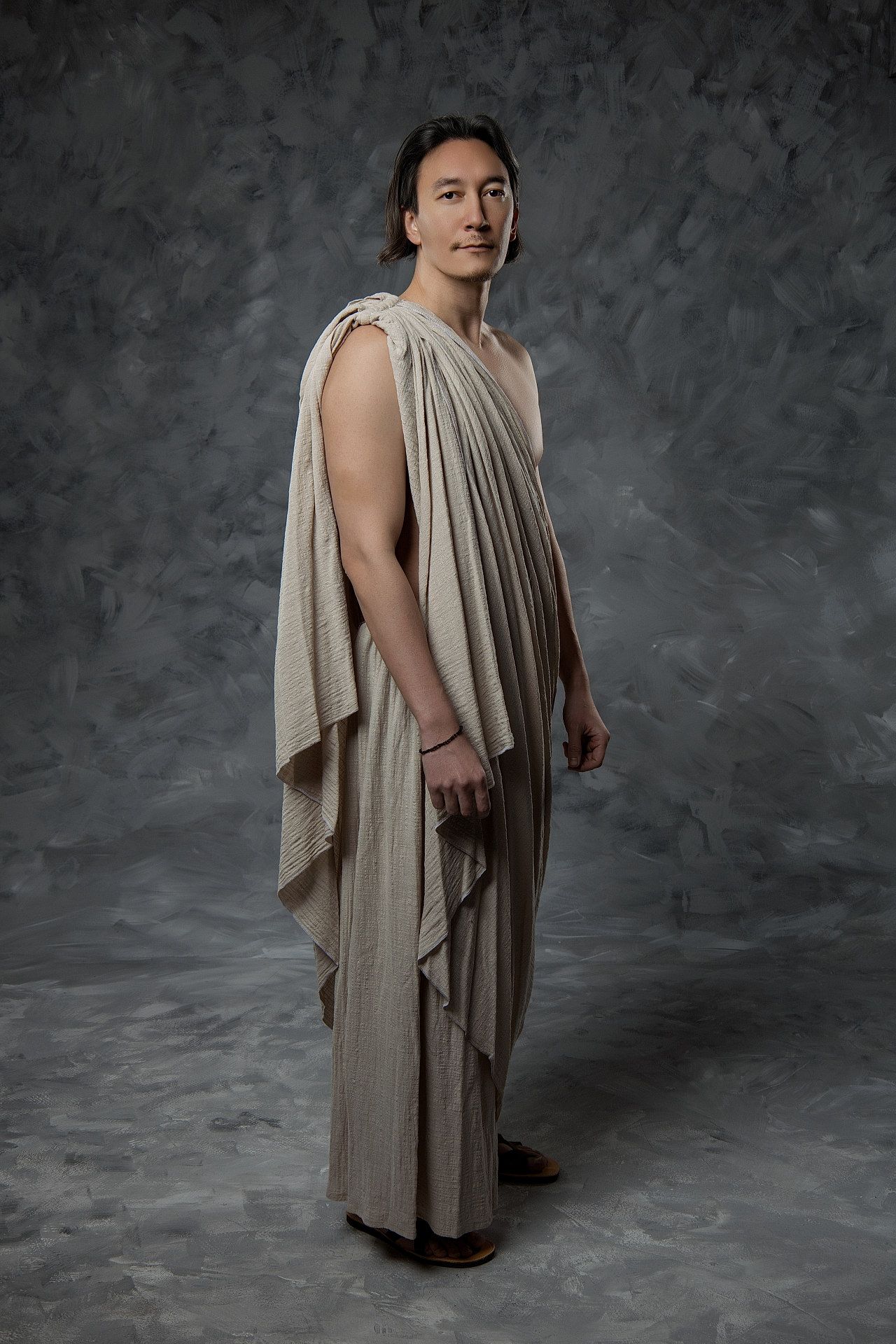 Ancient Greek philosopher-inspired portrait of figure in flowing beige draped garment , Hellenic-style photoshoot by GreekClick, Athens