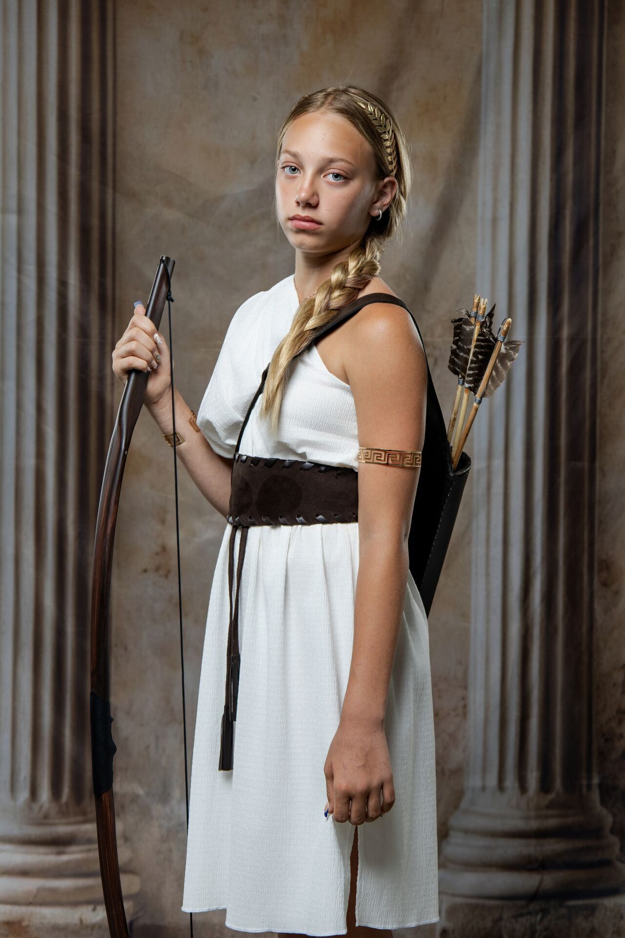 Artemis Greek mythology photoshoot experience in Athens with goddess costume, bow and arrow styling and GreekClick portraits.