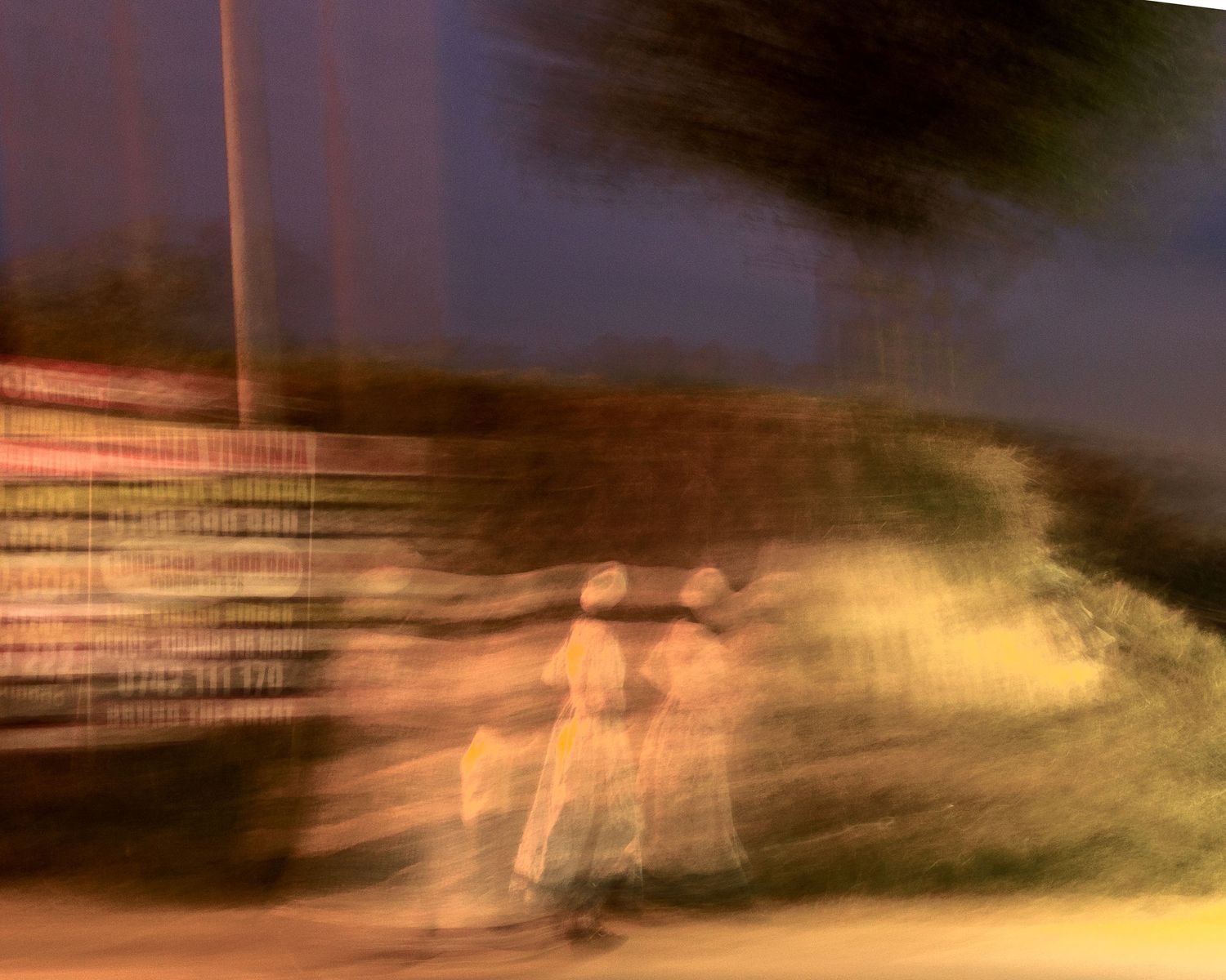Abstract long exposure motion blur of figures walking at night, experimental visual narrative capturing the energy of African streets.