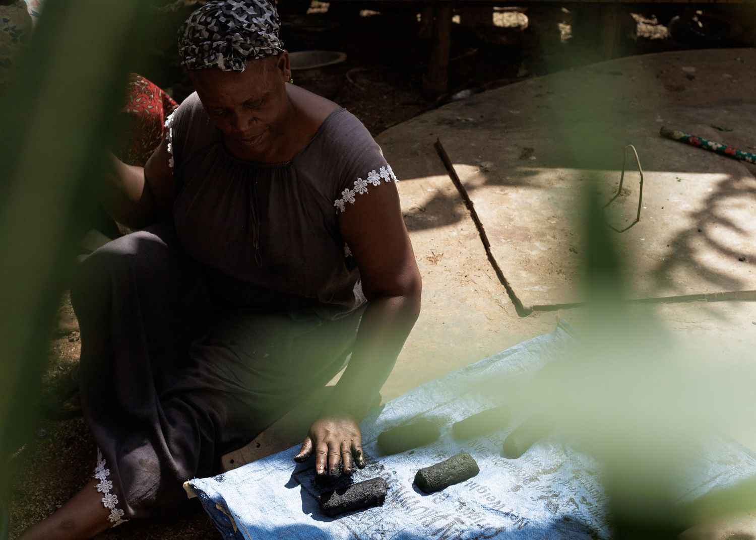 Sun-drying organic charcoal briquettes, a scaling green business project supported by microfinance in Tanzania by Naezi Eyes.