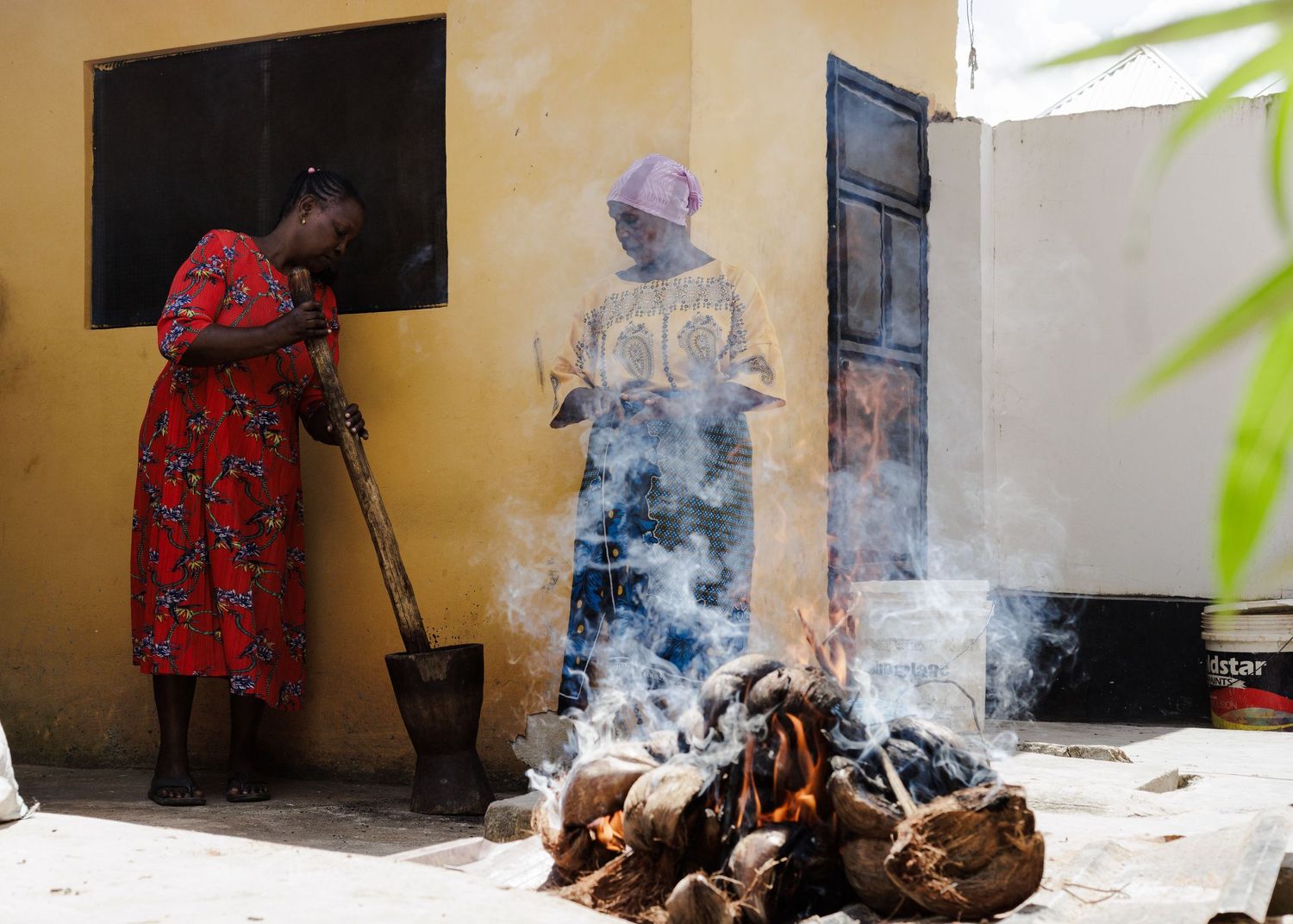 Process of recycling organic waste into charcoal, documenting sustainable manufacturing techniques by women in Dar es Salaam by Naezi Eyes