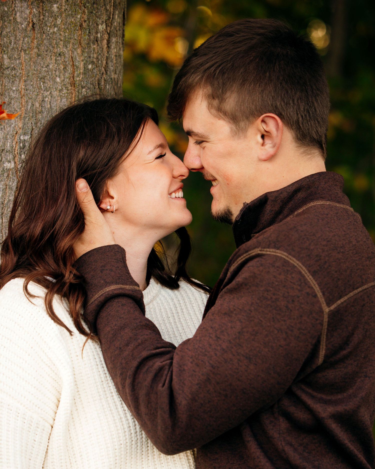 Intimate close-up of a couple sharing tender moments outdoors.