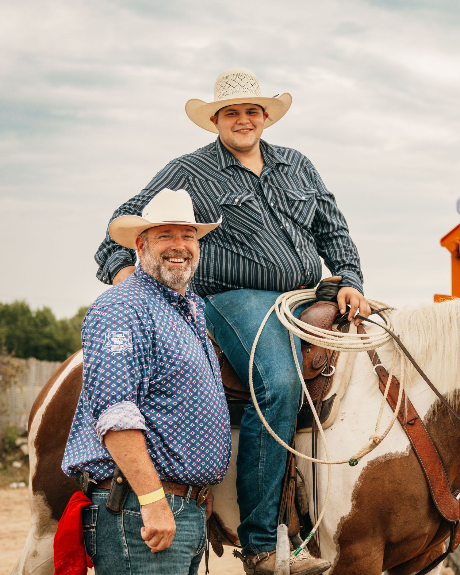 Cowboys on horseback gather in the arena during a western rodeo event.
