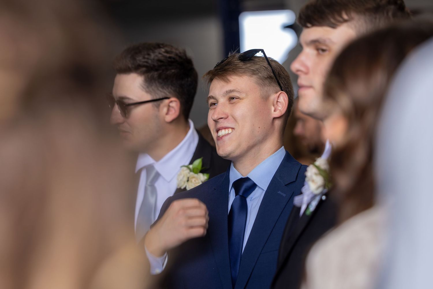 Guests in formal attire gathered at an elegant indoor celebration.