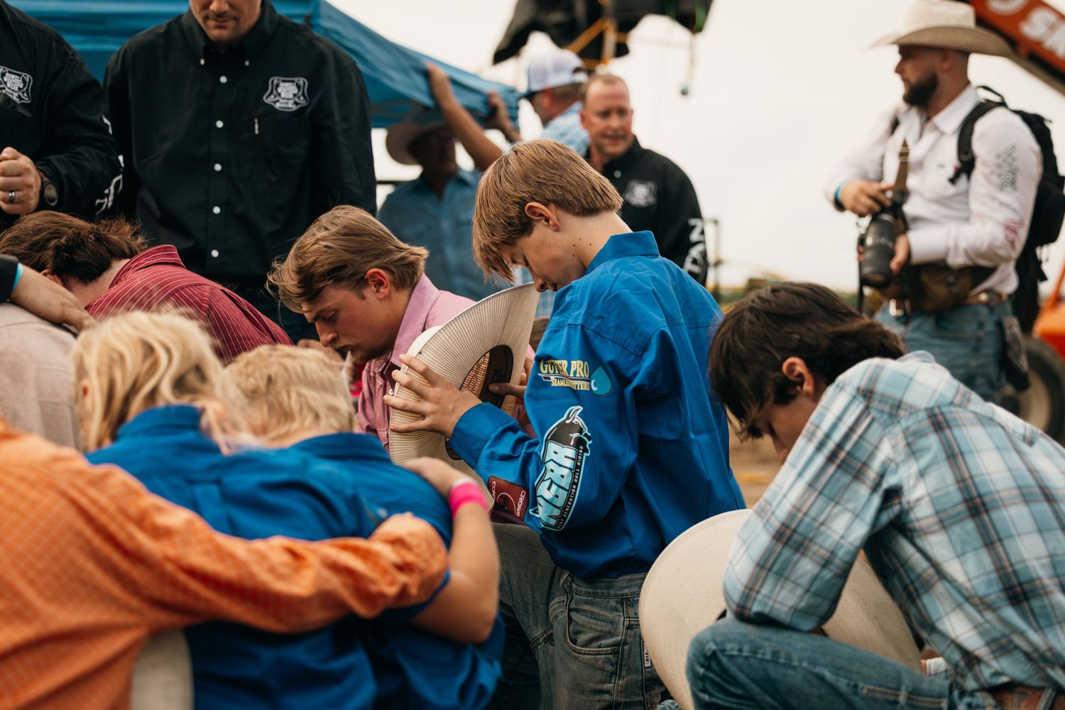 Group of people in western attire gathered together at a casual outdoor event.