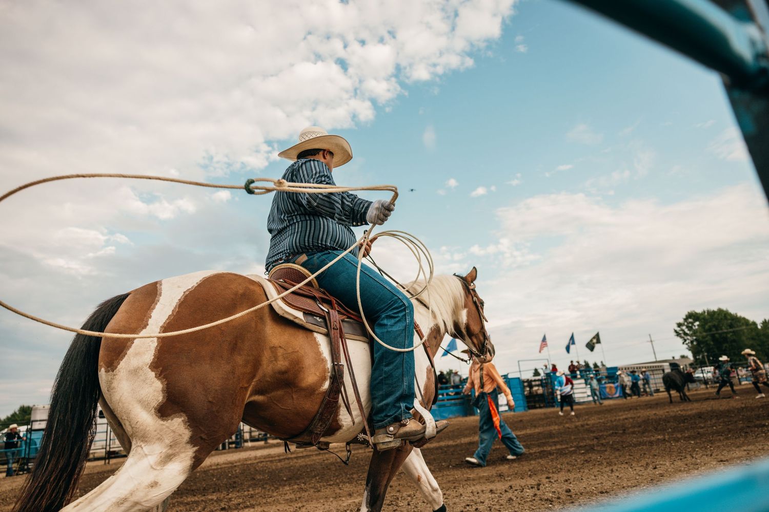 Western rodeo action sequence showing riders competing in an outdoor arena.