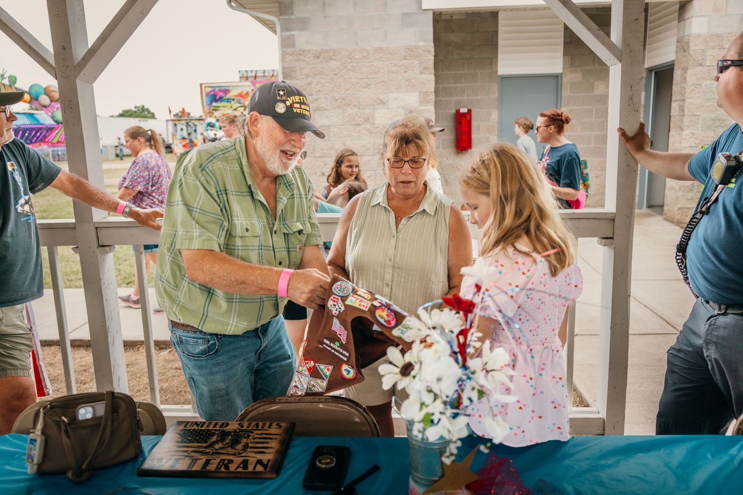 People mingling and socializing under a covered outdoor pavilion space.
