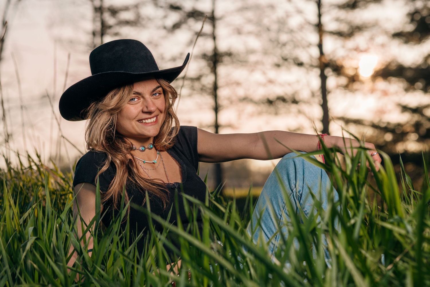 Couple poses together in tall grass during a countryside photo session.