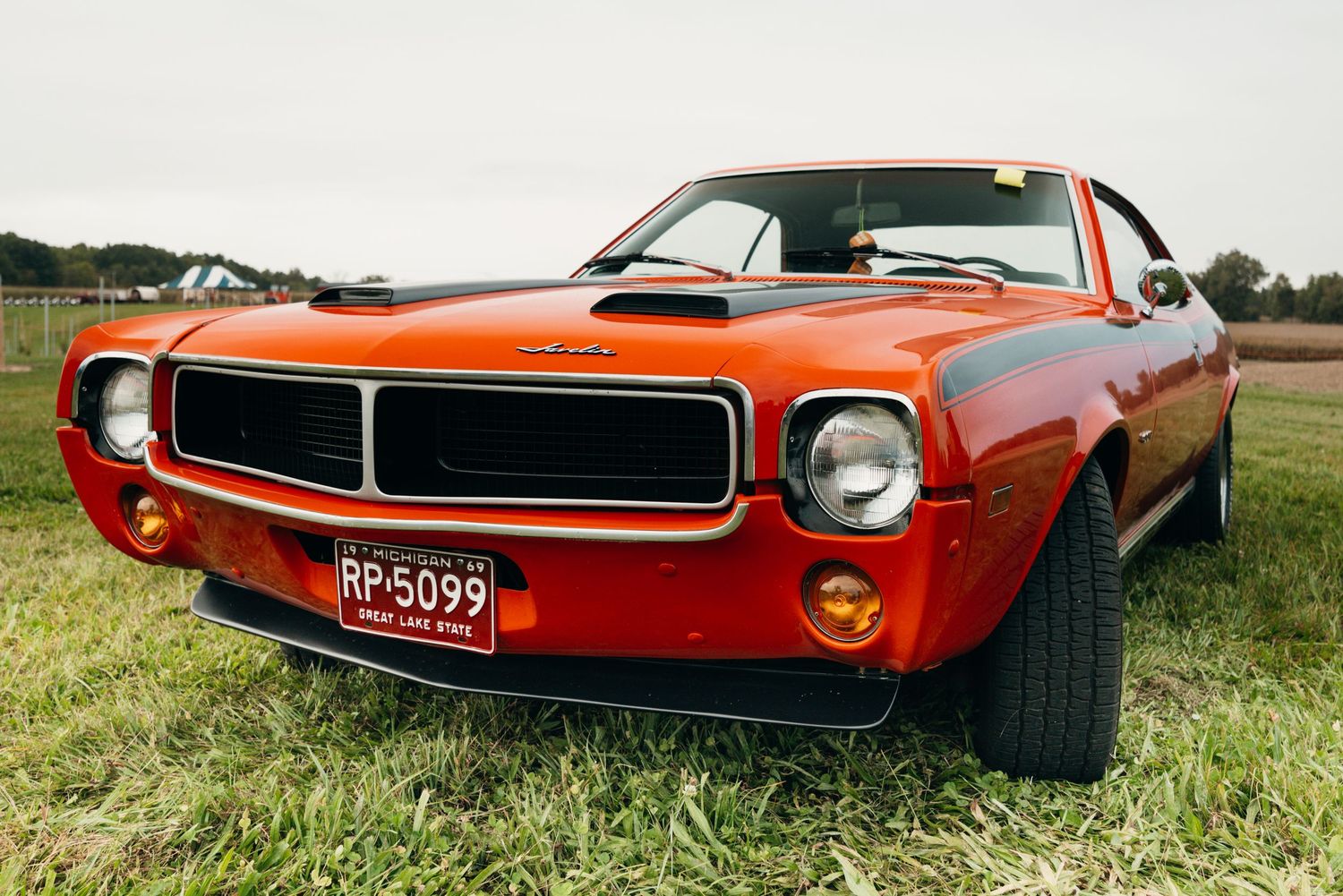 Classic red muscle car photographed from different angles showing its sleek vintage design.
