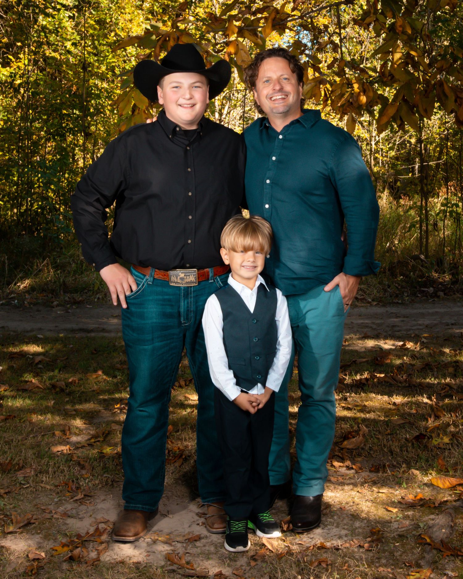 Family portrait session in a wooded setting during golden hour.