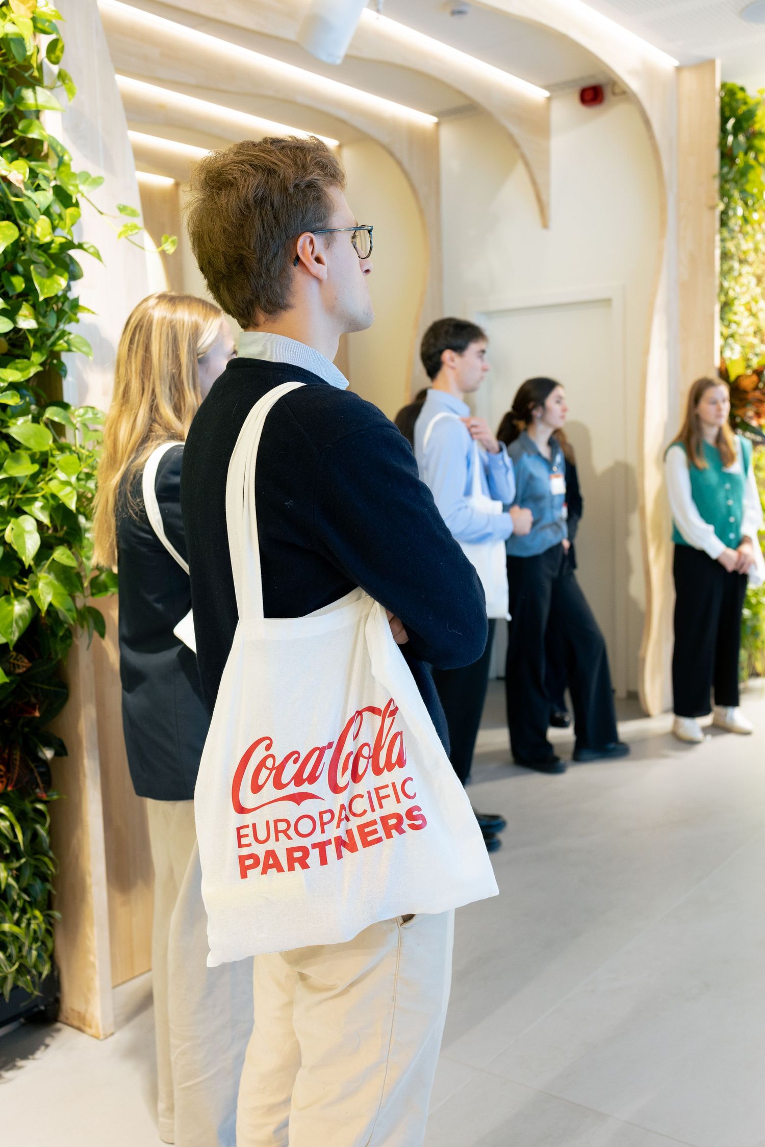 Photographe corporate Bruxelles – participants écoutant présentation lors événement professionnel entreprise Coca-Cola