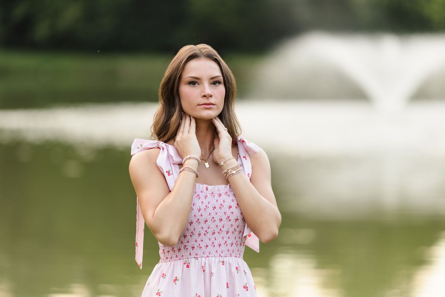Series of outdoor portrait photos featuring pink floral dress by a lake.