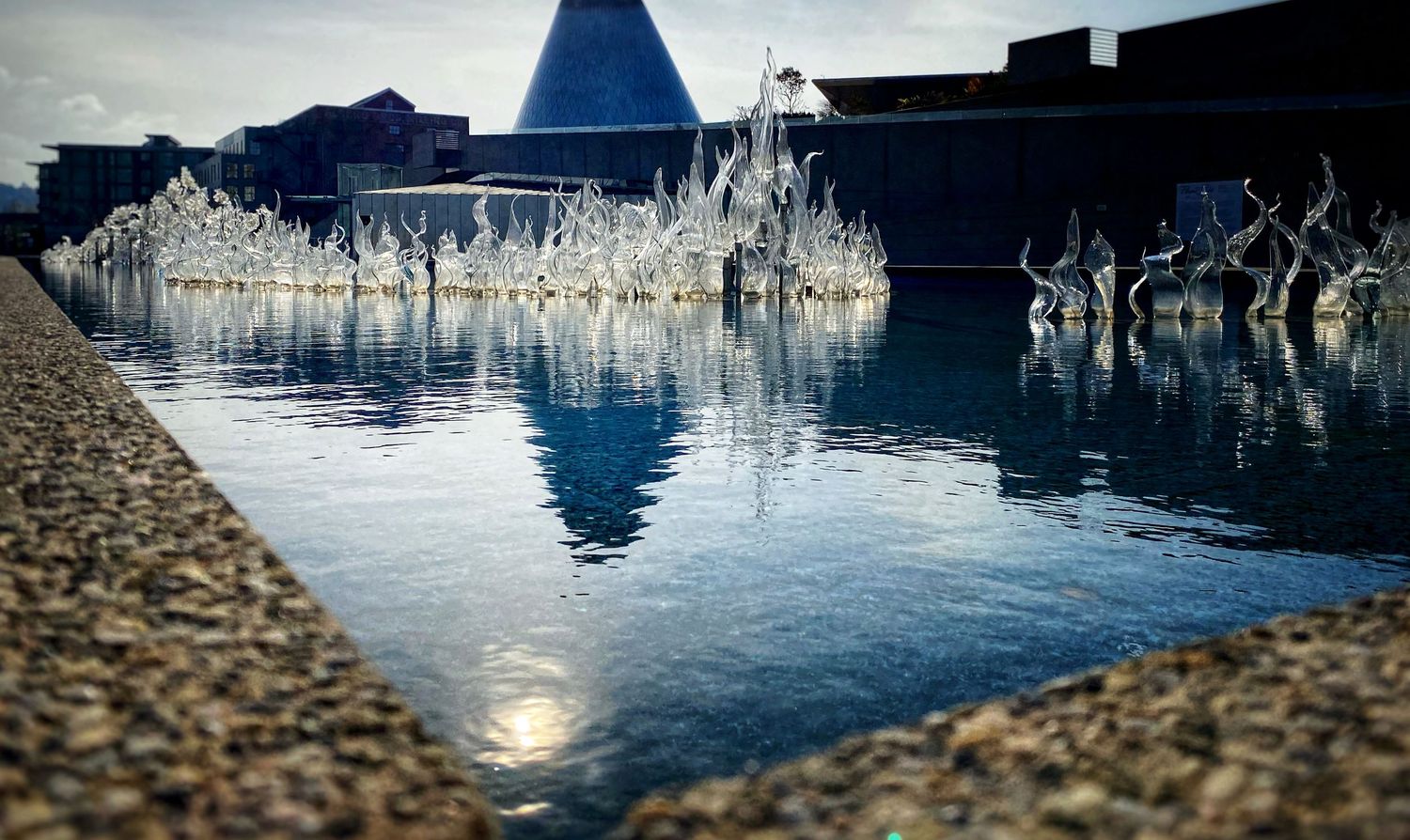 Tranquil water reflections create a serene abstract pattern in blue tones.