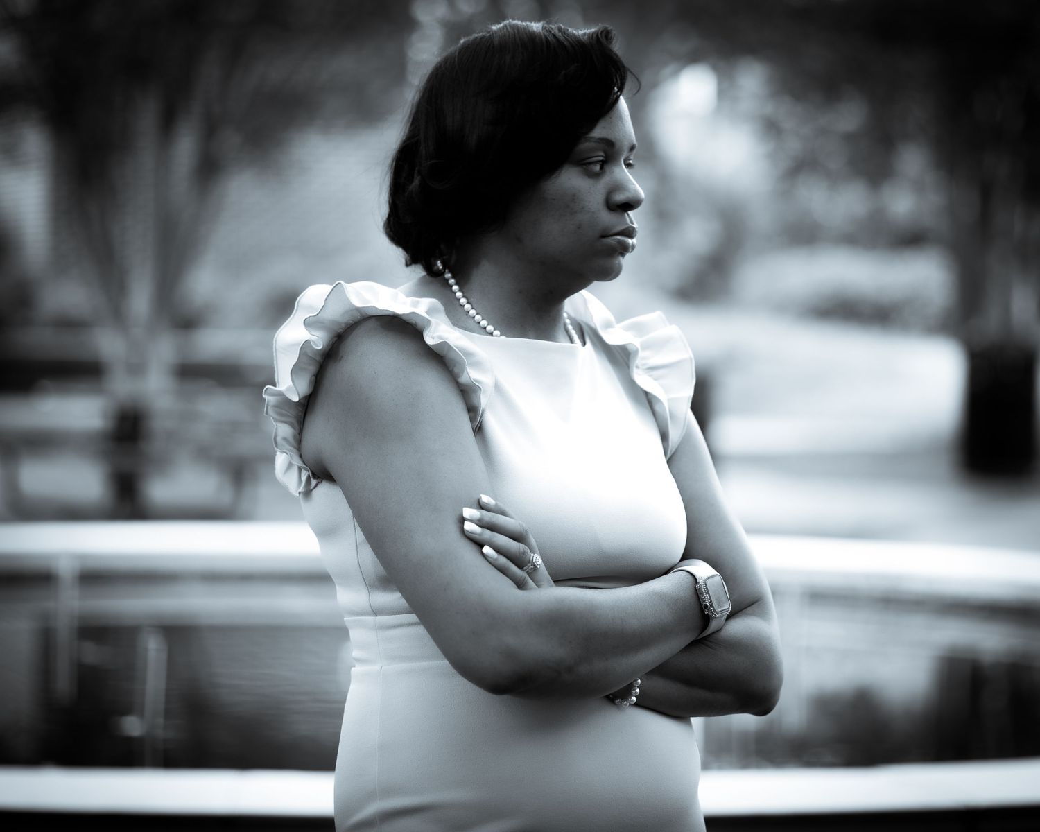 Black and white portrait series showing contemplative poses against blurred background.