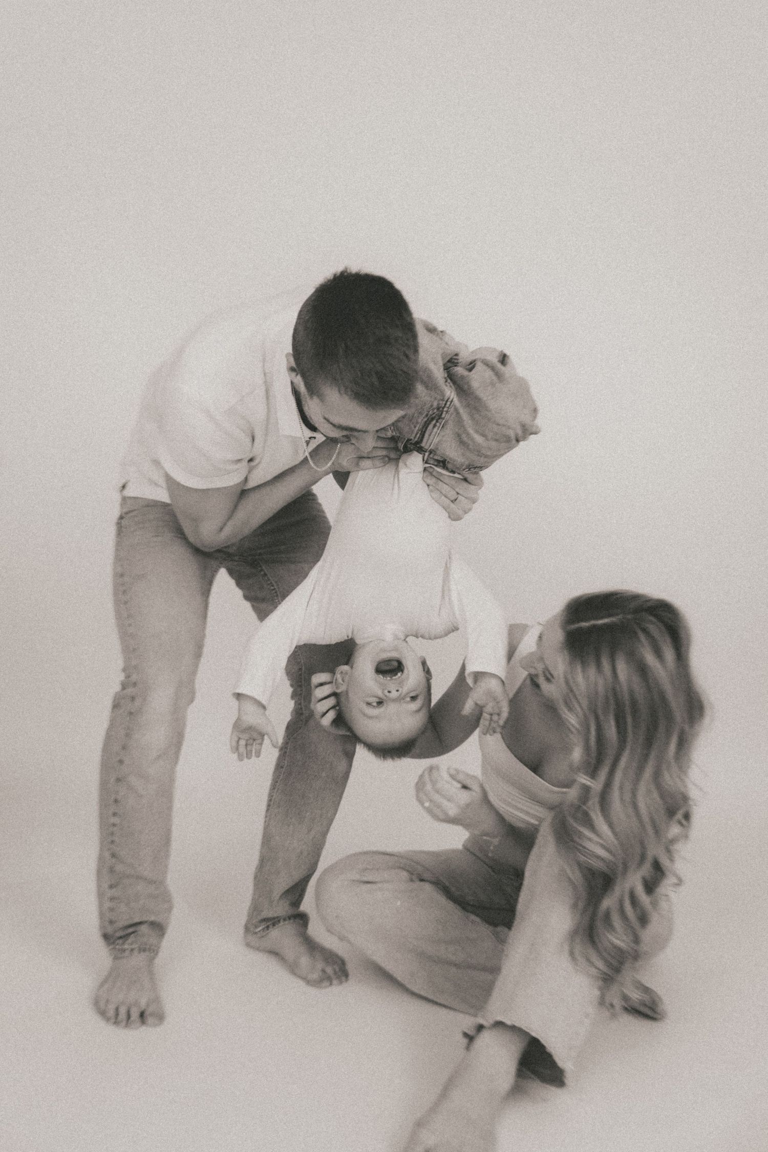 Black and white photo series showing tender family moments against a white background.