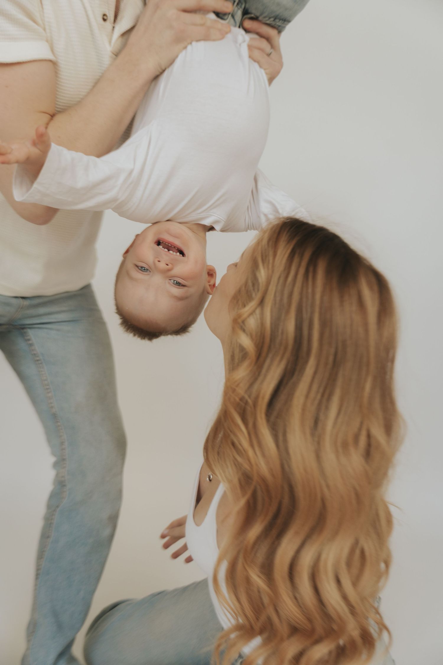 A person in a white top and blue jeans stands against a white background in a series of cropped photos.