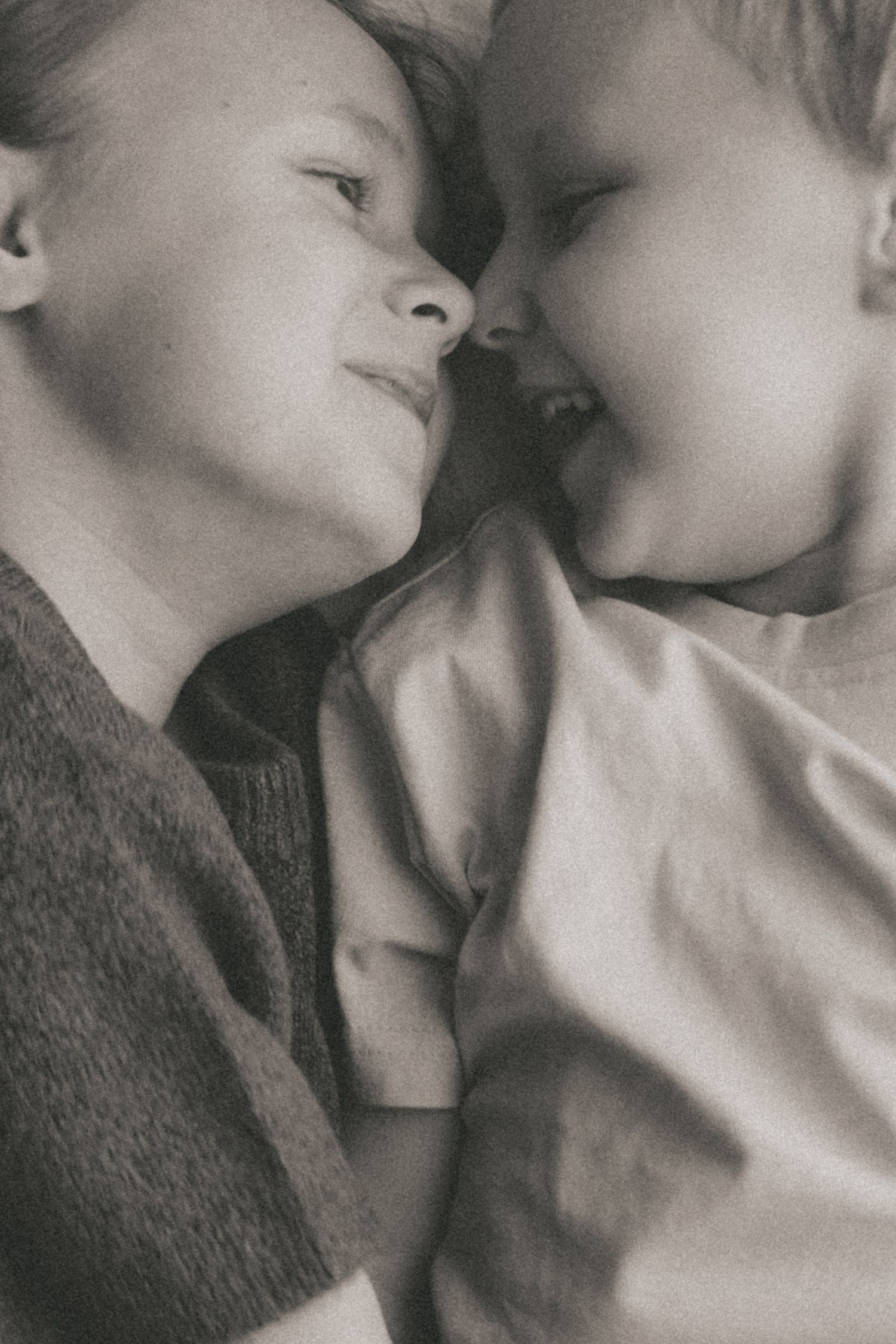 Artistic black and white profile shots of two people in intimate poses.
