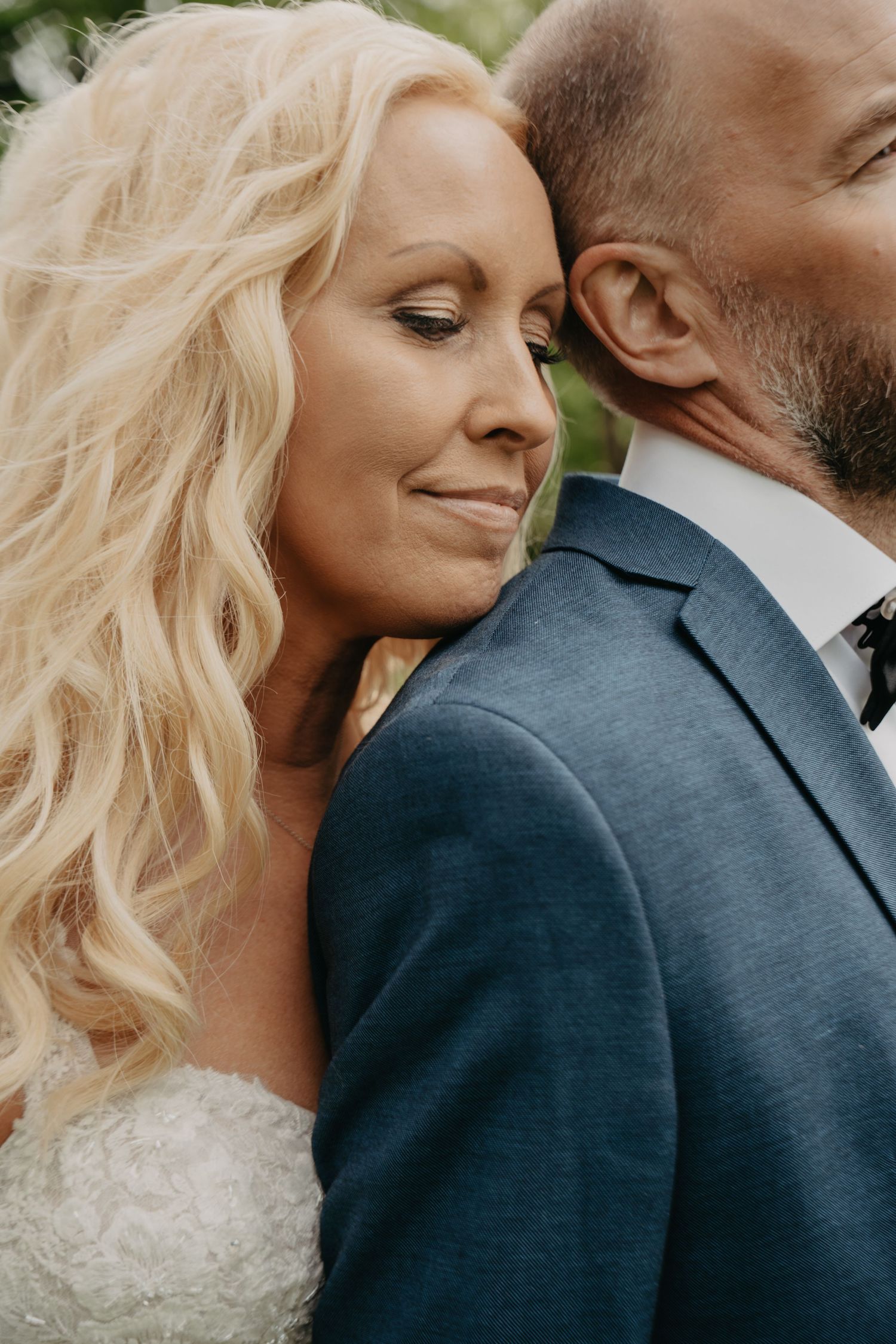 An intimate moment between newlyweds captured in soft natural lighting.