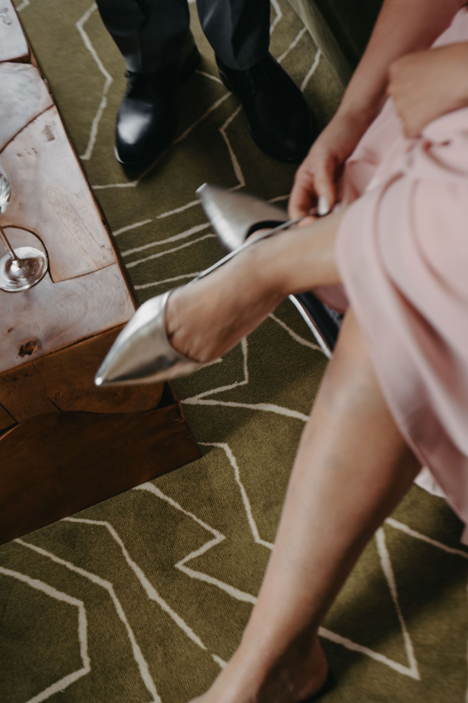 Close-up shots of pink and white fabric against a dark floor.