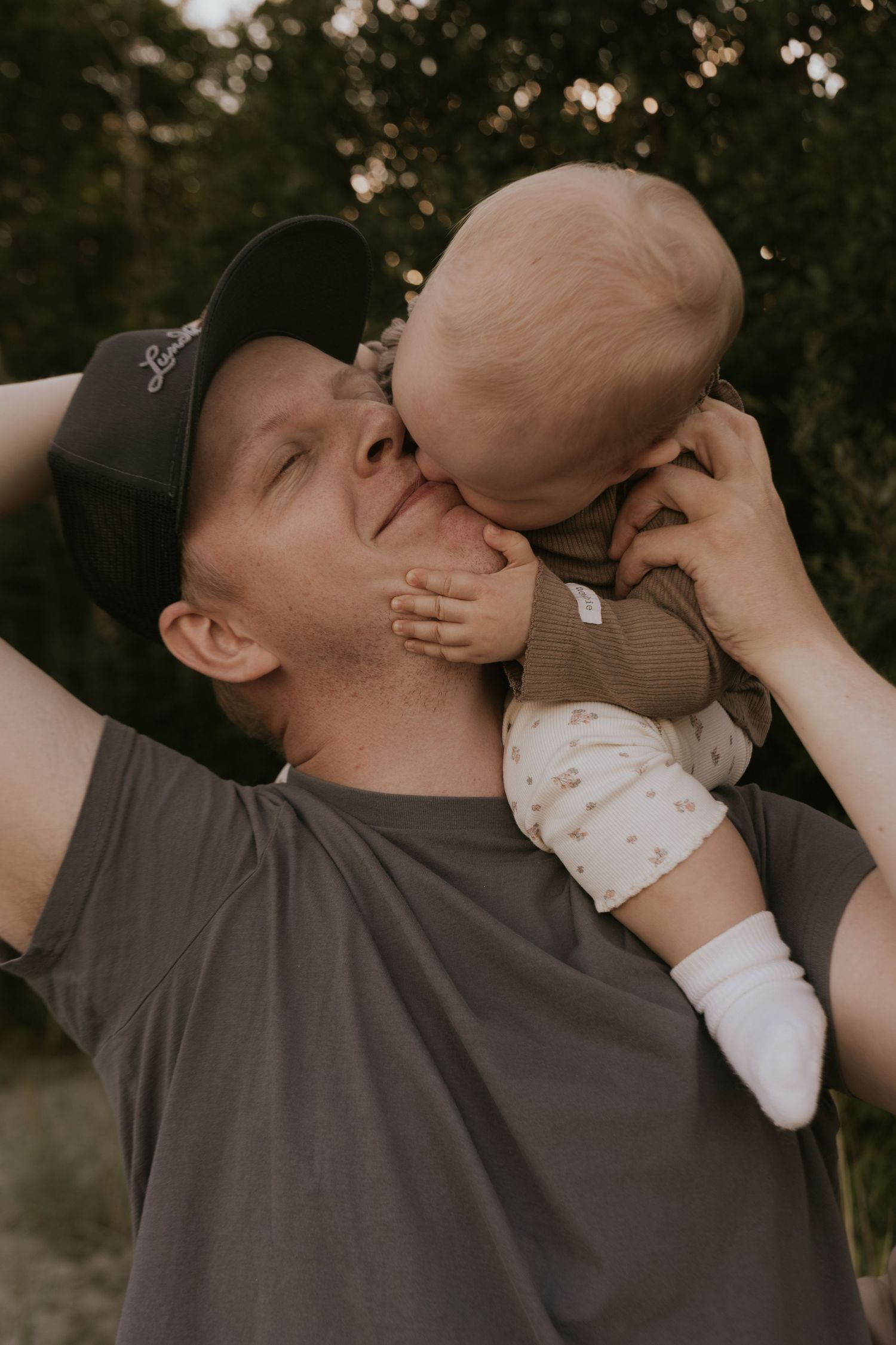 Playful outdoor portrait series showing affectionate interaction between two people.