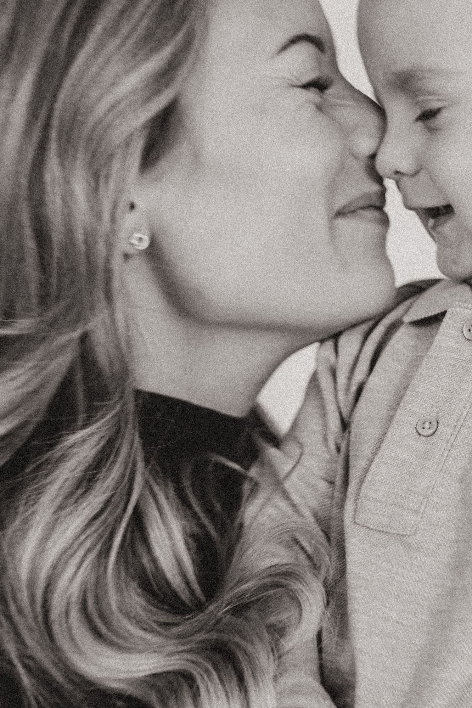 A tender black and white collage showing intimate mother and child moments of affection and bonding.