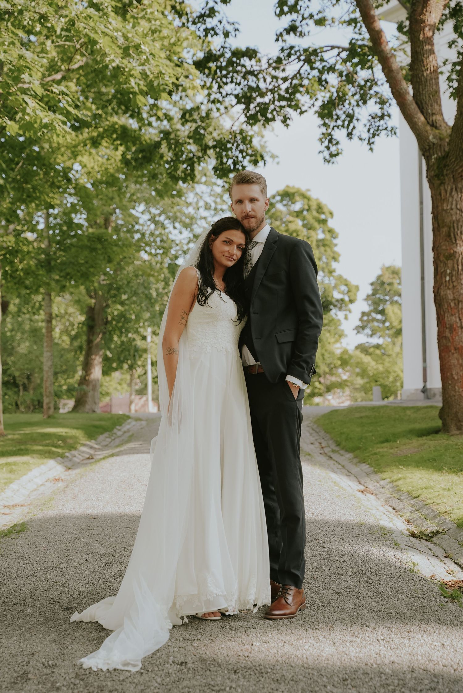 A series of romantic wedding photos showing the couple's feet and dress details on a gravel path under green trees.