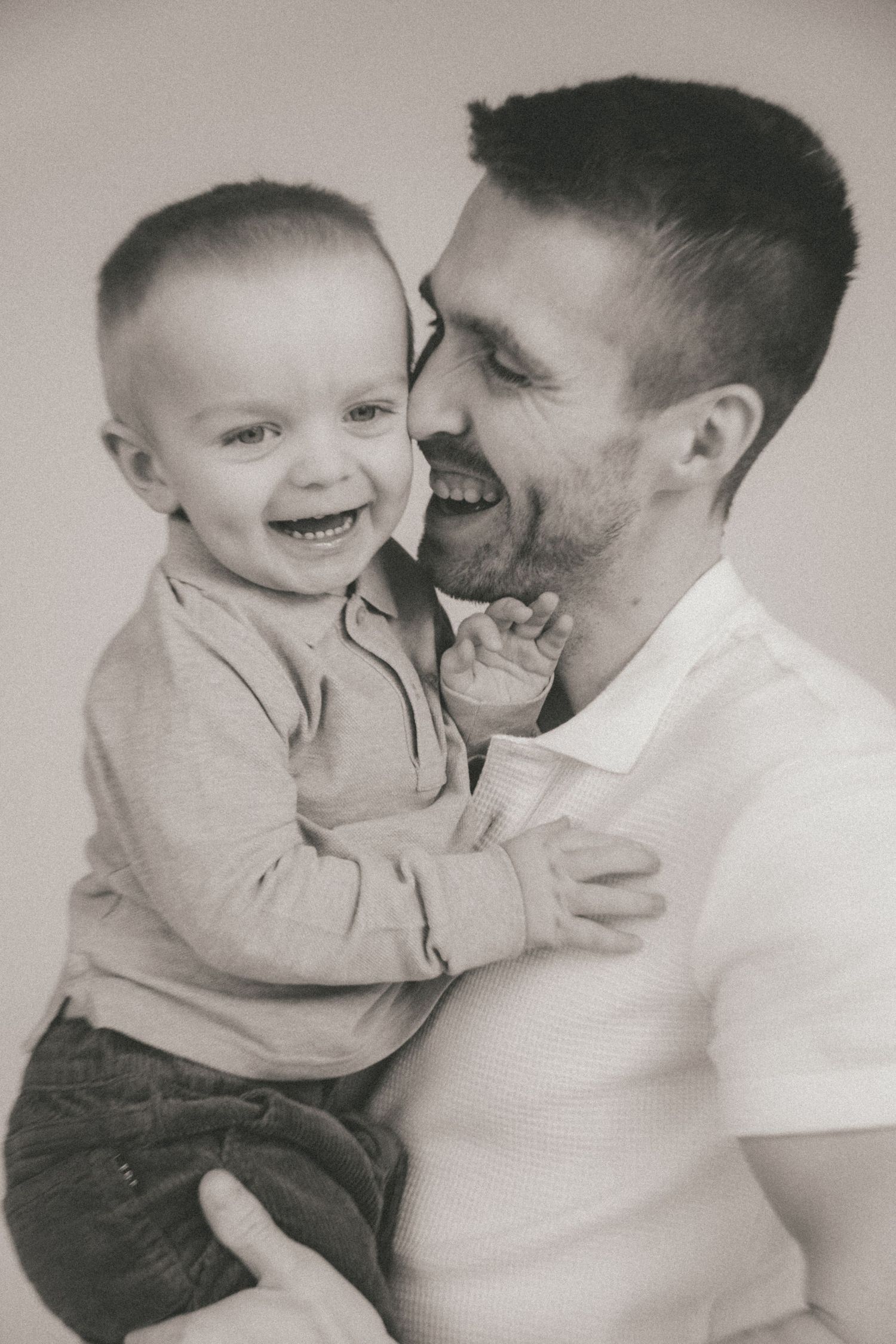 Sweet monochrome sequence captures tender playful interactions between adult and young child.