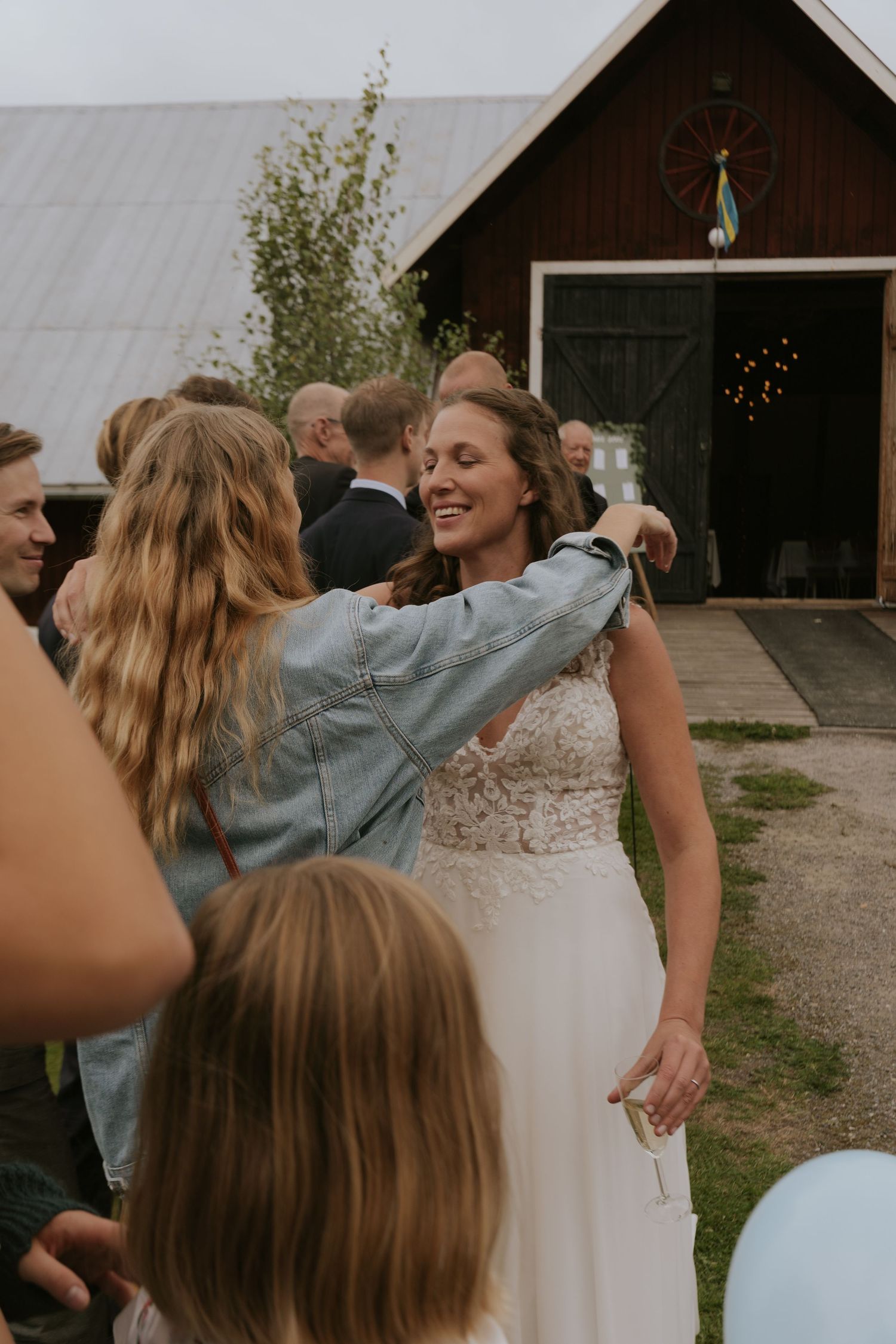 People dancing and celebrating at a rustic barn wedding reception.