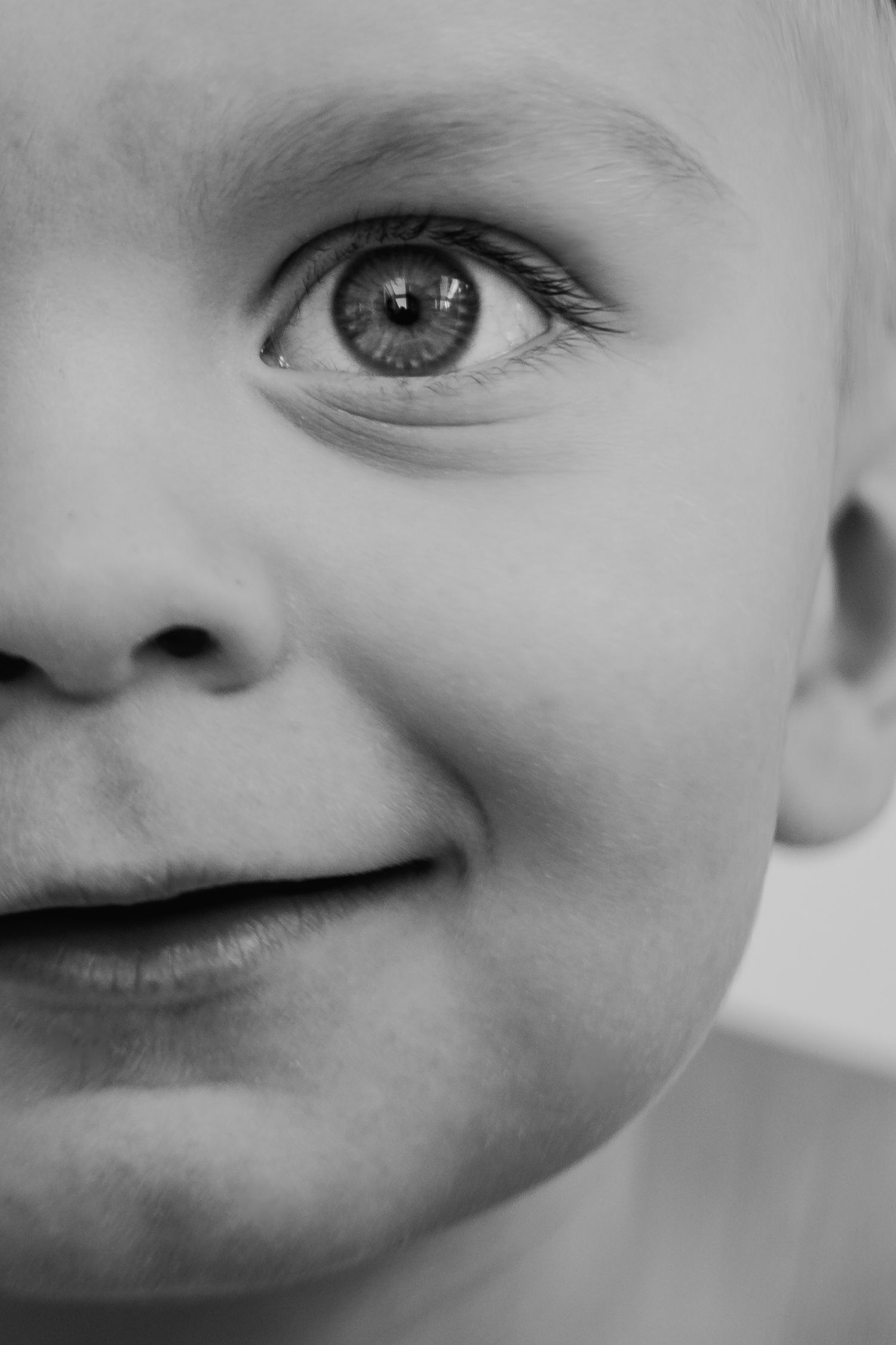 Black and white close-up photo showing a series of facial features and expressions in a minimalist artistic style.