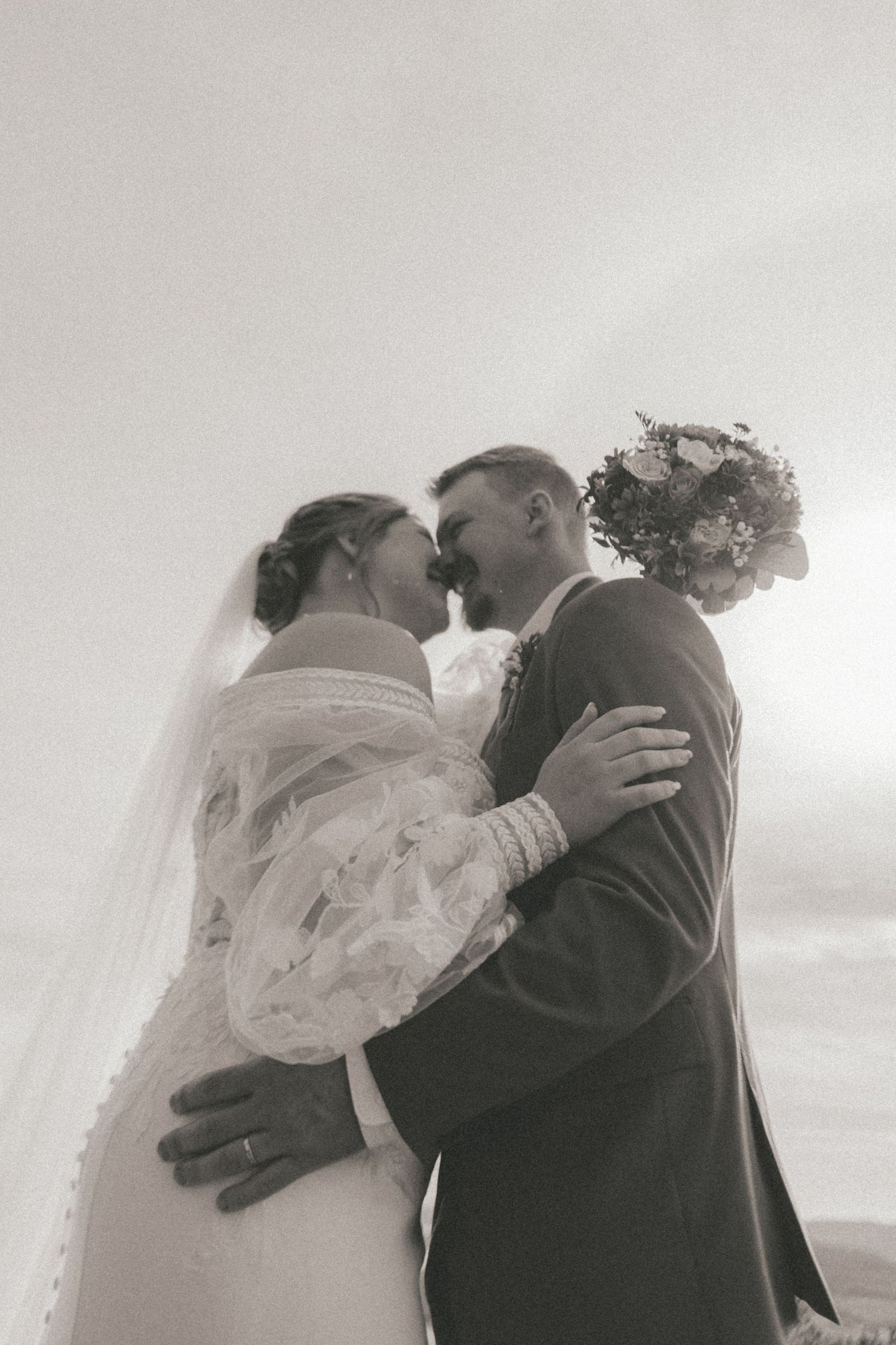 Dreamy black and white wedding portraits showing intimate moments between newlyweds.