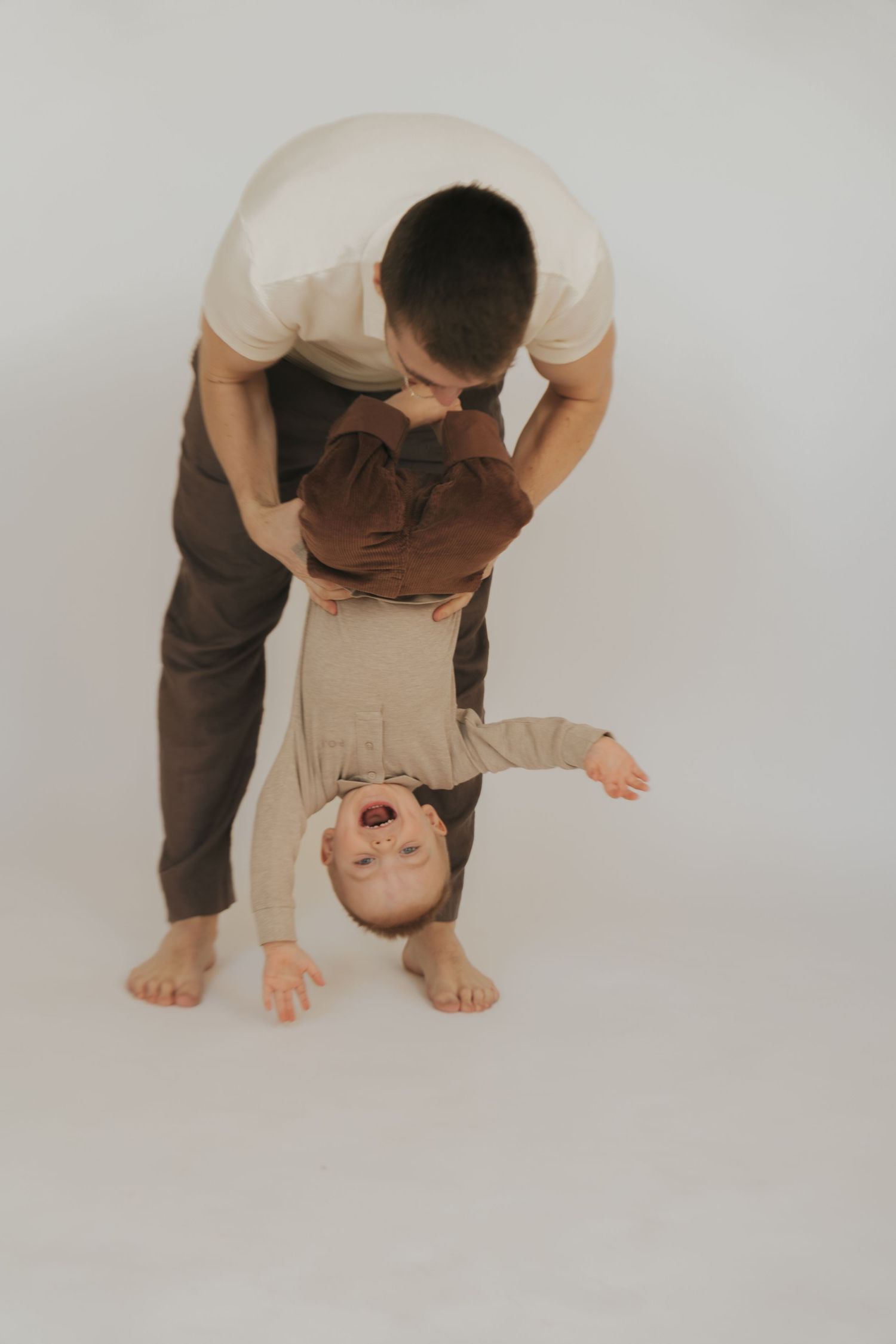 A sequence of photos showing someone bending forward and flipping their head upside down in a graceful movement.