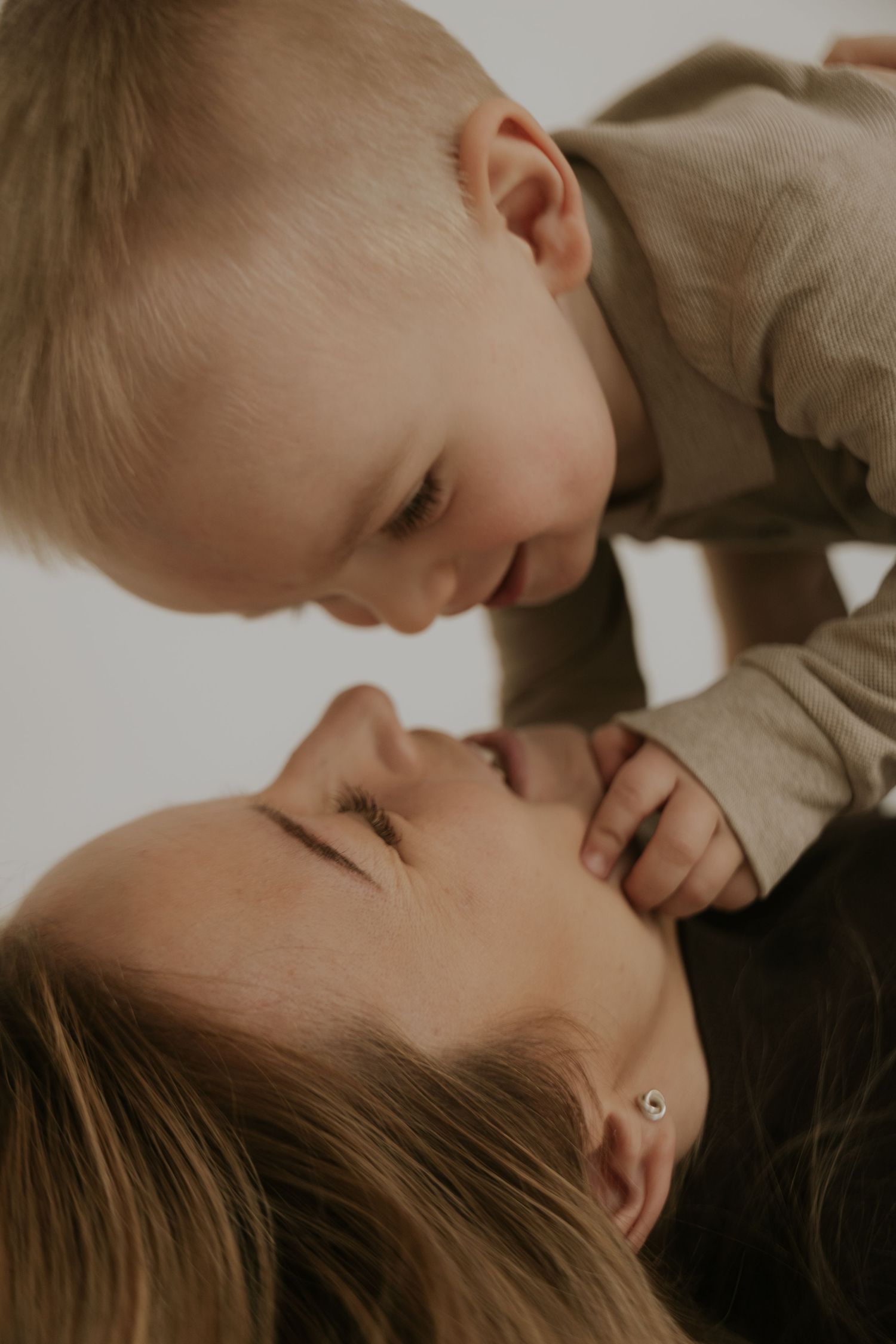 A tender moment shared between parent and child in a series of intimate black and white portraits.